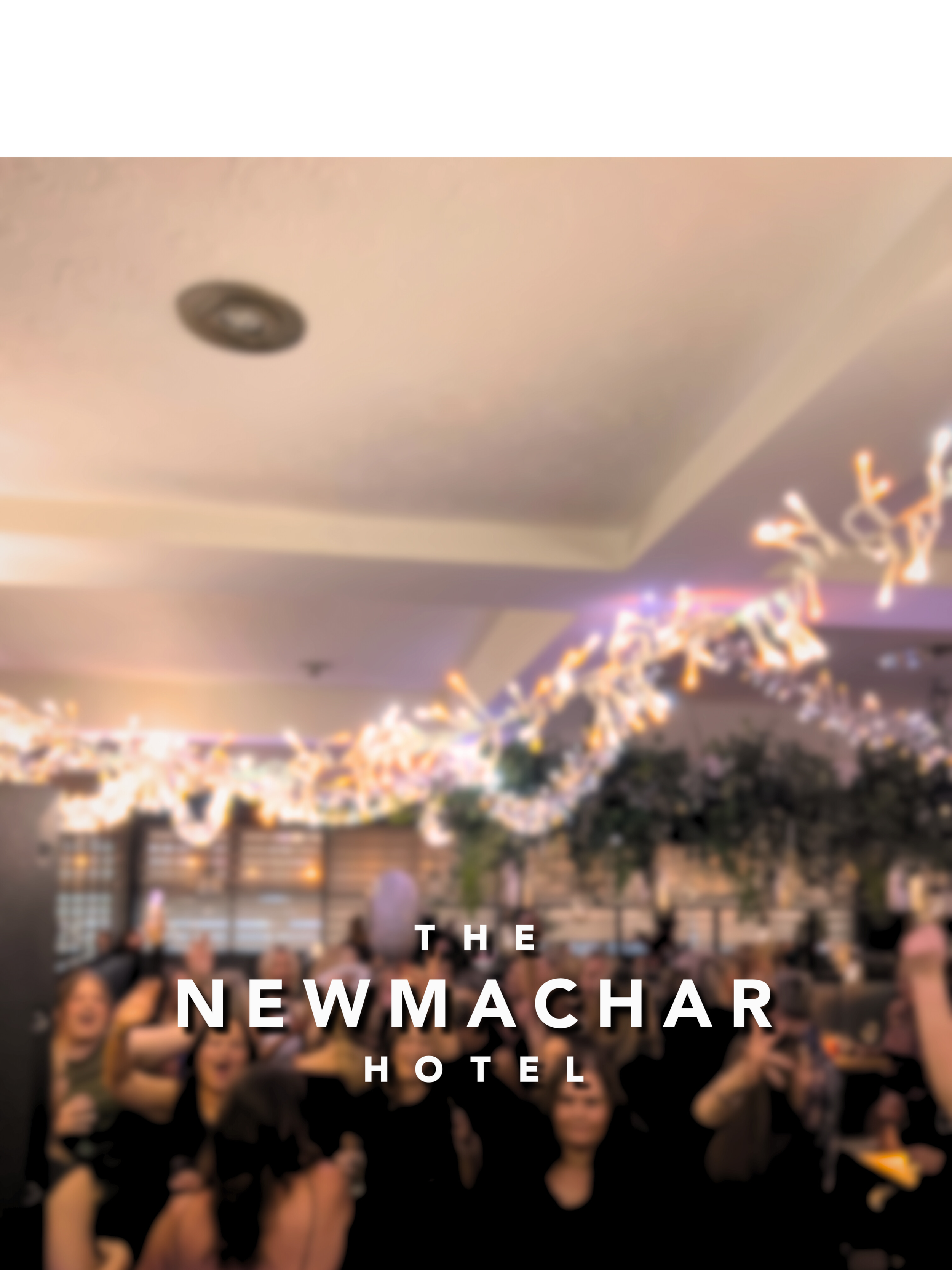 Group of women celebrating at a party with string lights and balloons