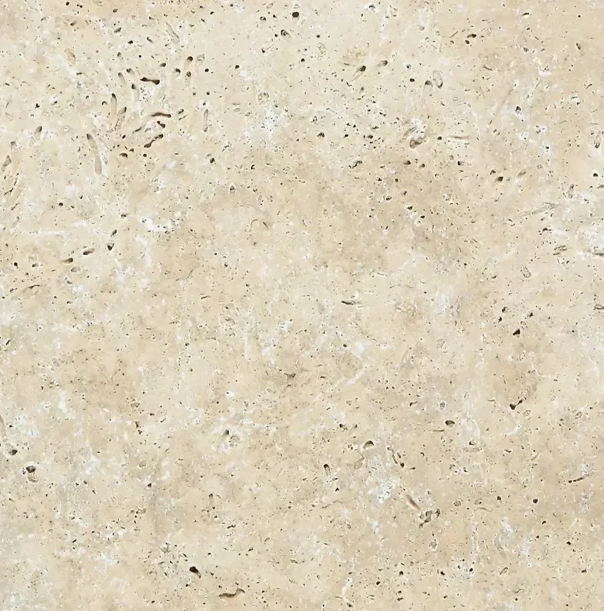 Close-up of a beige, speckled stone or tile surface.