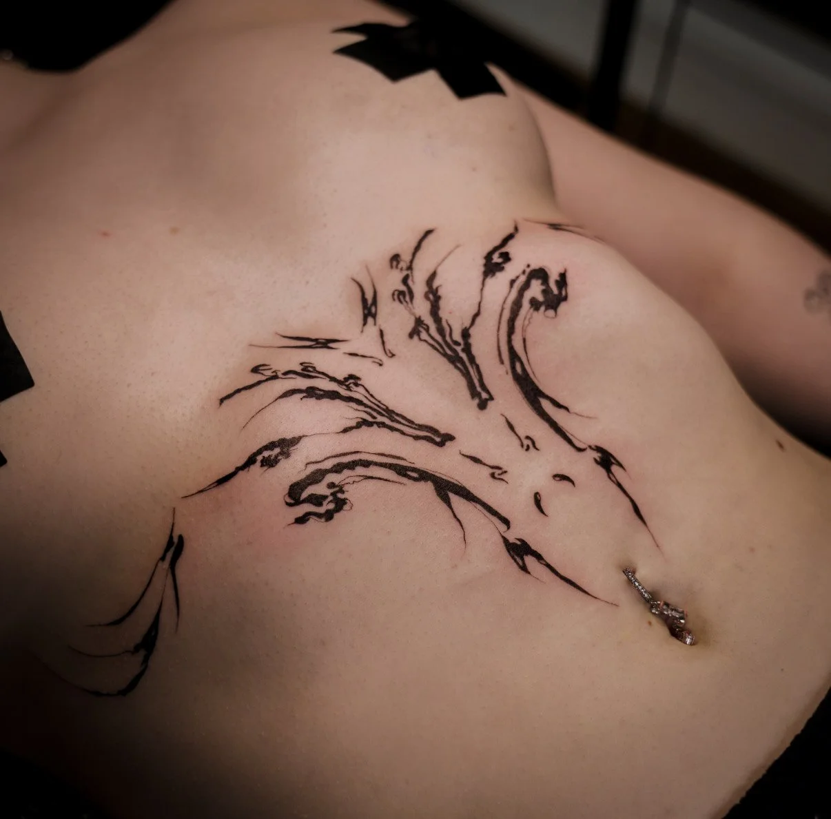 Sigilism gothic underboob tattoo by Thomas Tranchina