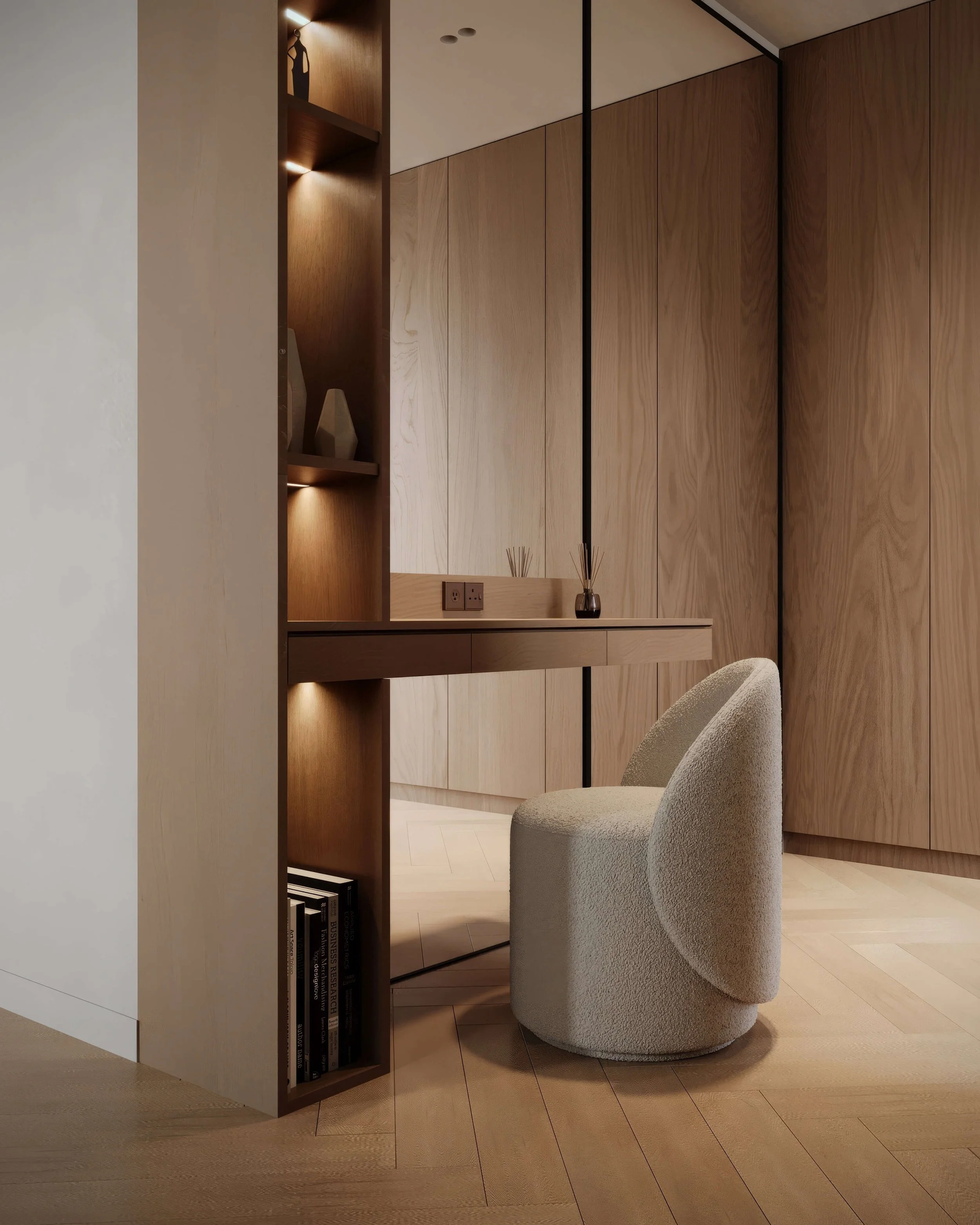 Modern interior with a beige upholstered chair, wooden wall panels, built-in shelves with vases, and a wooden desk with reed diffusers.