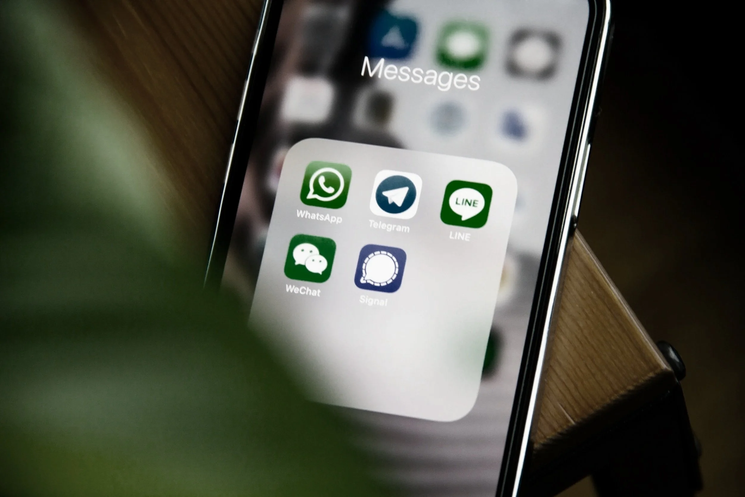 A smartphone screen showing a dog training support folder named 'Messages' with six messaging app icons, including WhatsApp, Telegram, LINE, WeChat, Signal, and one partially visible.
