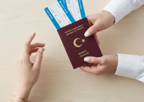 Person handing over a passport and boarding passes to another person.