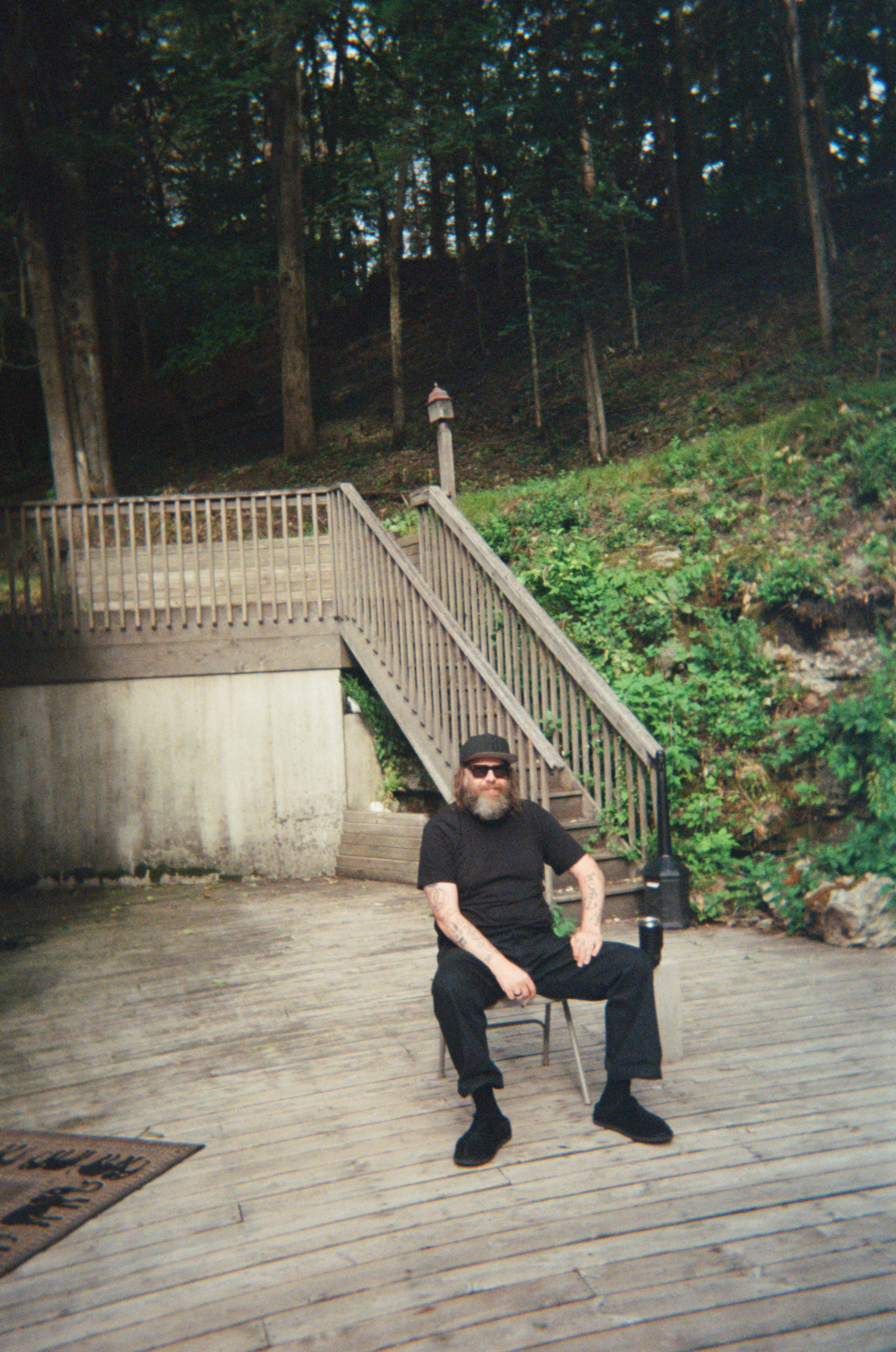 Brad Cook Seated on a Deck