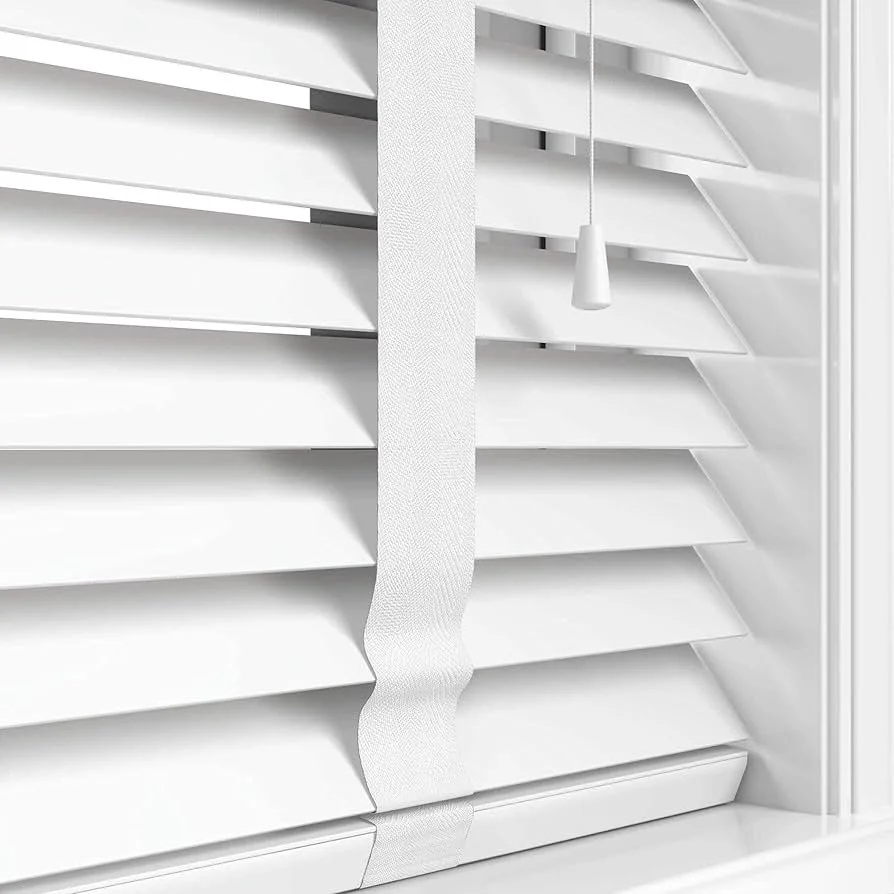 White plantation shutters with a white pull cord.