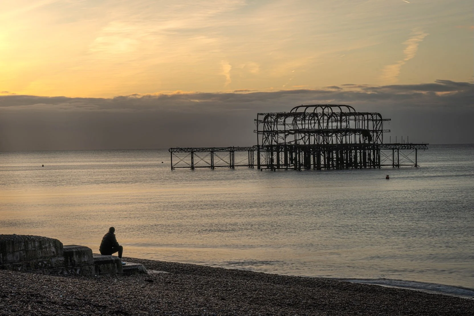 A quiet moment on Brighton beach at sunrise, looking out towards the remains of the West Pier. 