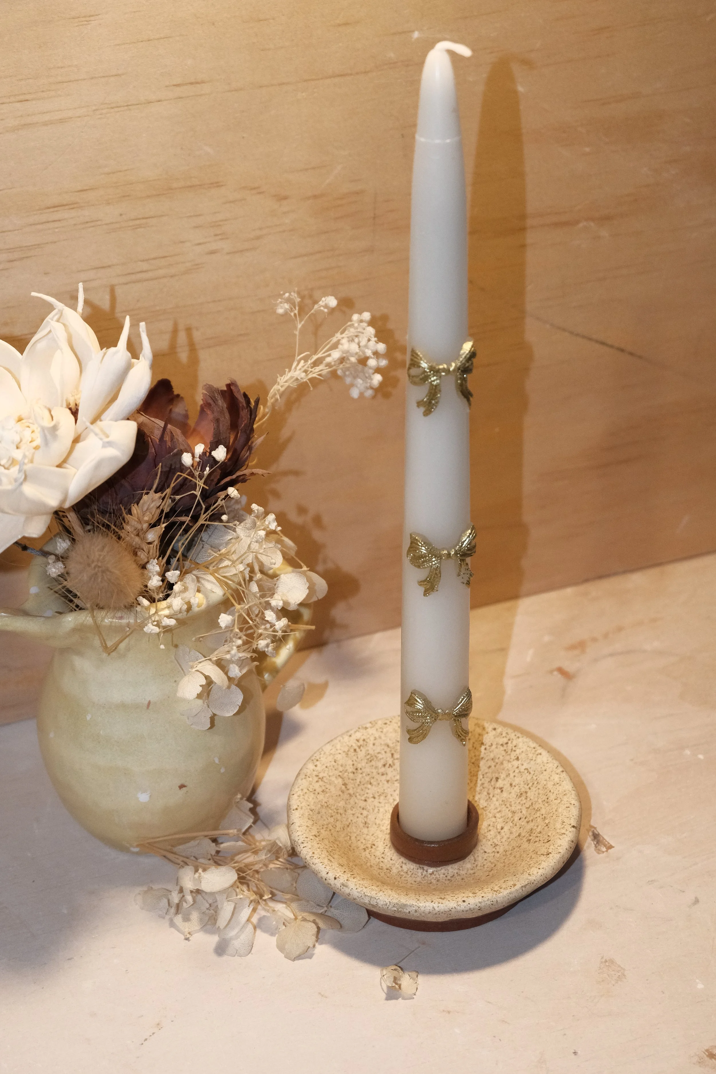 Ceramic taper candlestick holder in a matte speckled cream