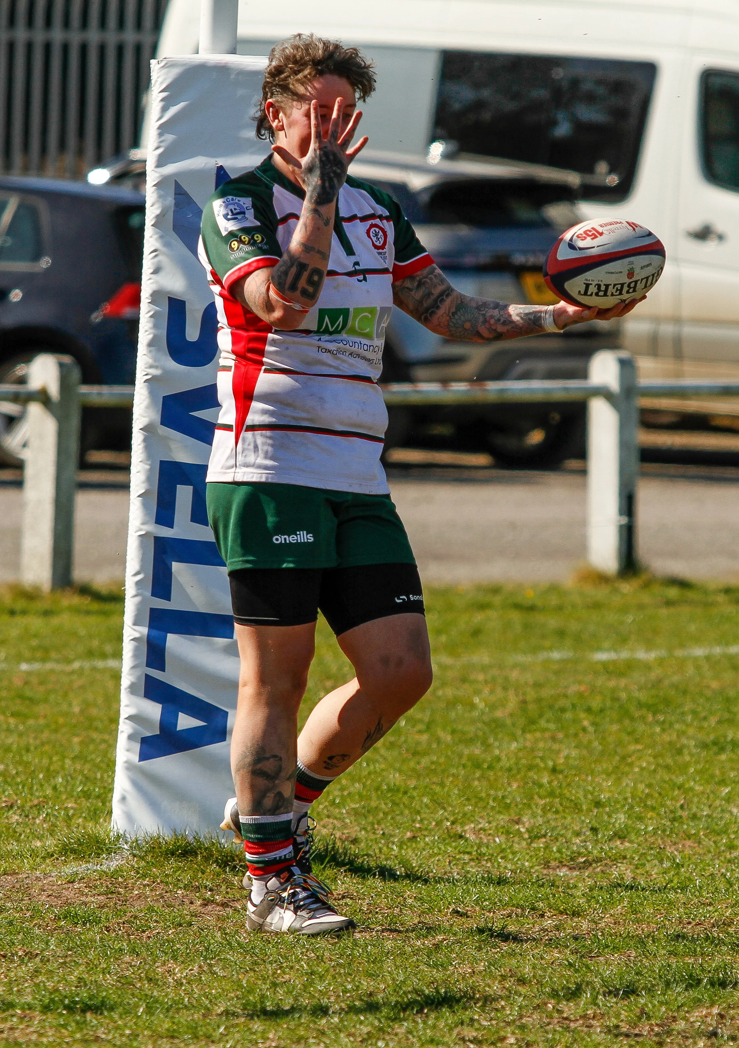 female rugby player scoring a try and celebrating
