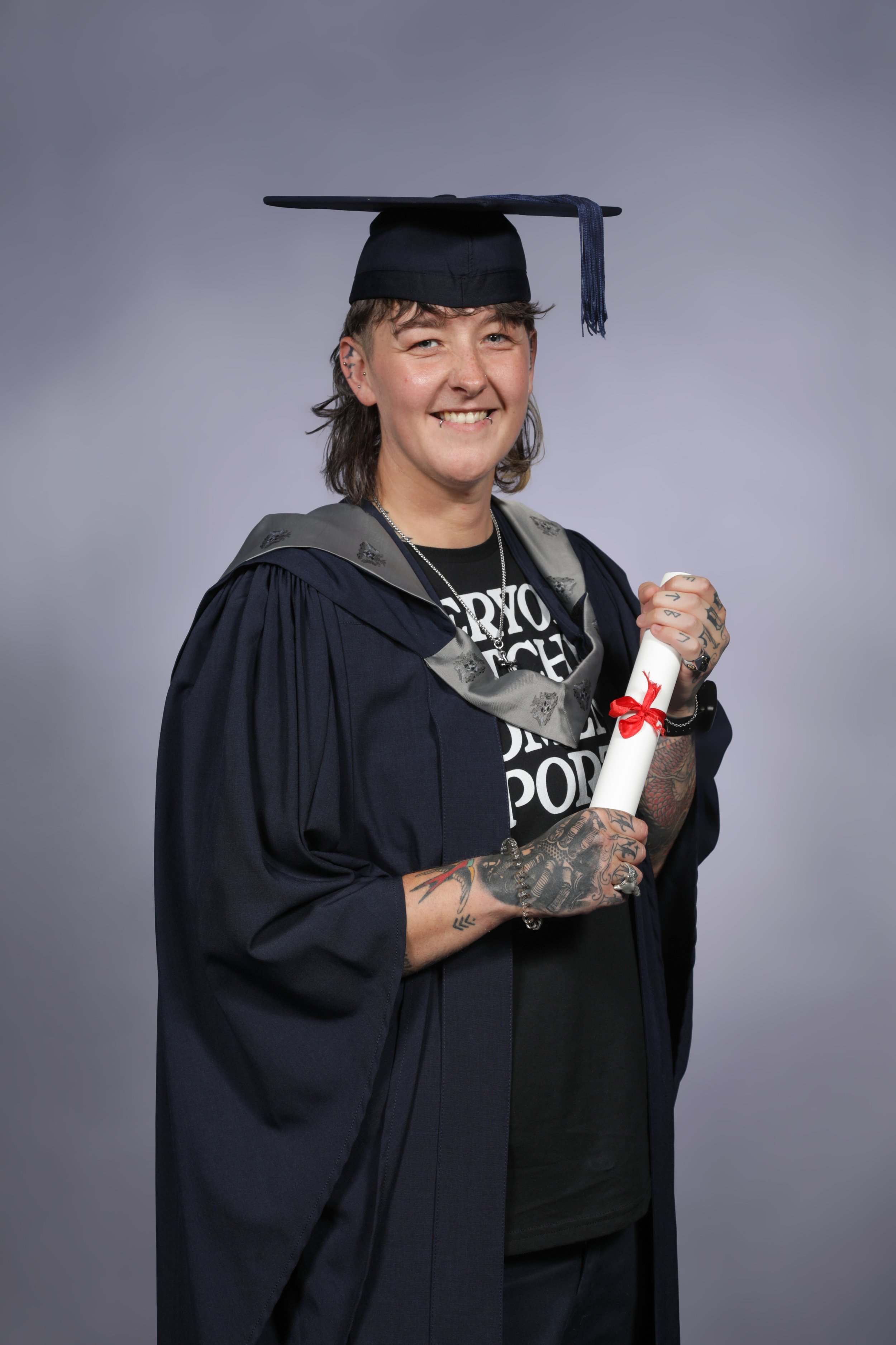 female holding degree qualification