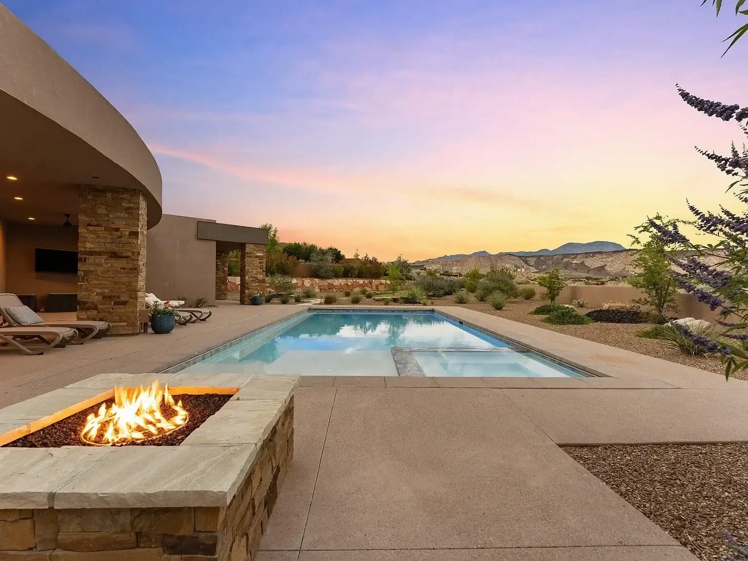 Luxury outdoor pool with fire feature and red rock views at twilight, Southern Utah