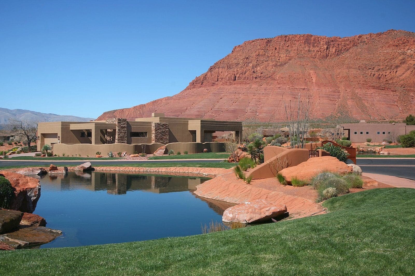 Luxury desert home with red rock cliffs in Southern Utah, representative of second-home properties served by KeyBird Home Watch in St. George