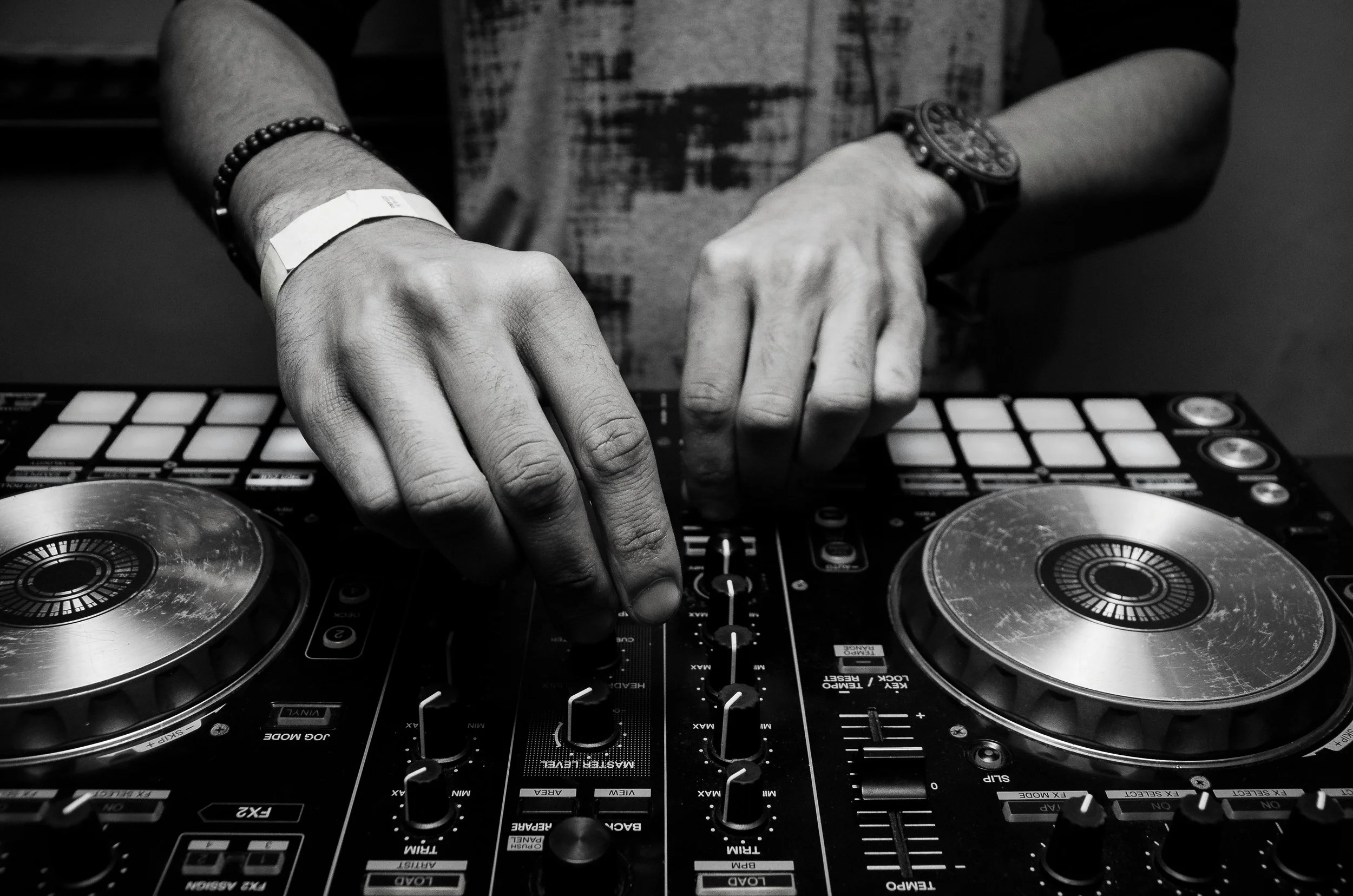 DJ's hands on a mixer, private dj for your party, luxury lifestyle management, lifestyle concierge Istanbul. Discreet bespoke lifestyle management for private members. Tailored lifestyle management services delivered with discretion