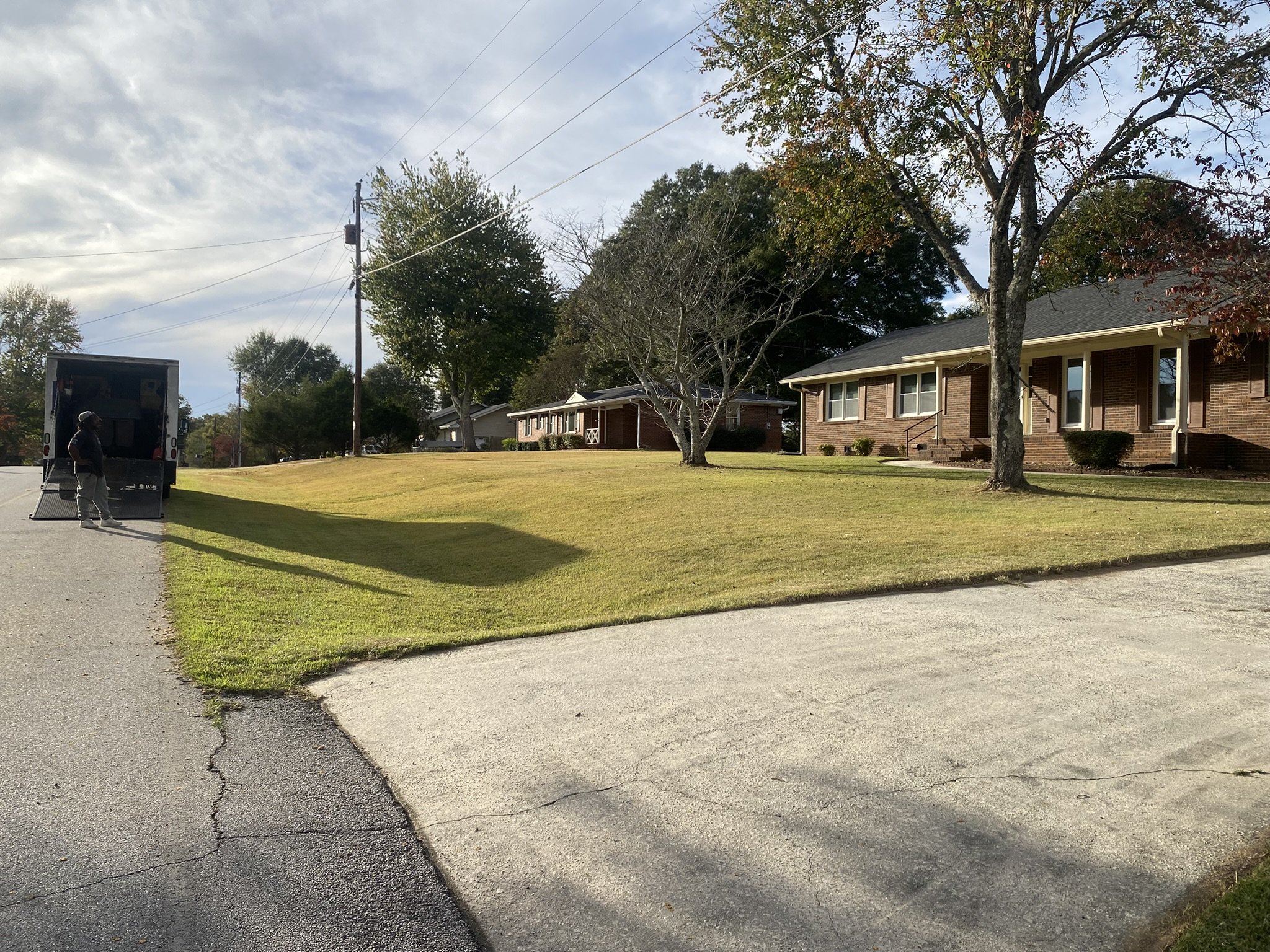 Property maintenance service vehicle parked on a residential street during lawn and exterior service work.