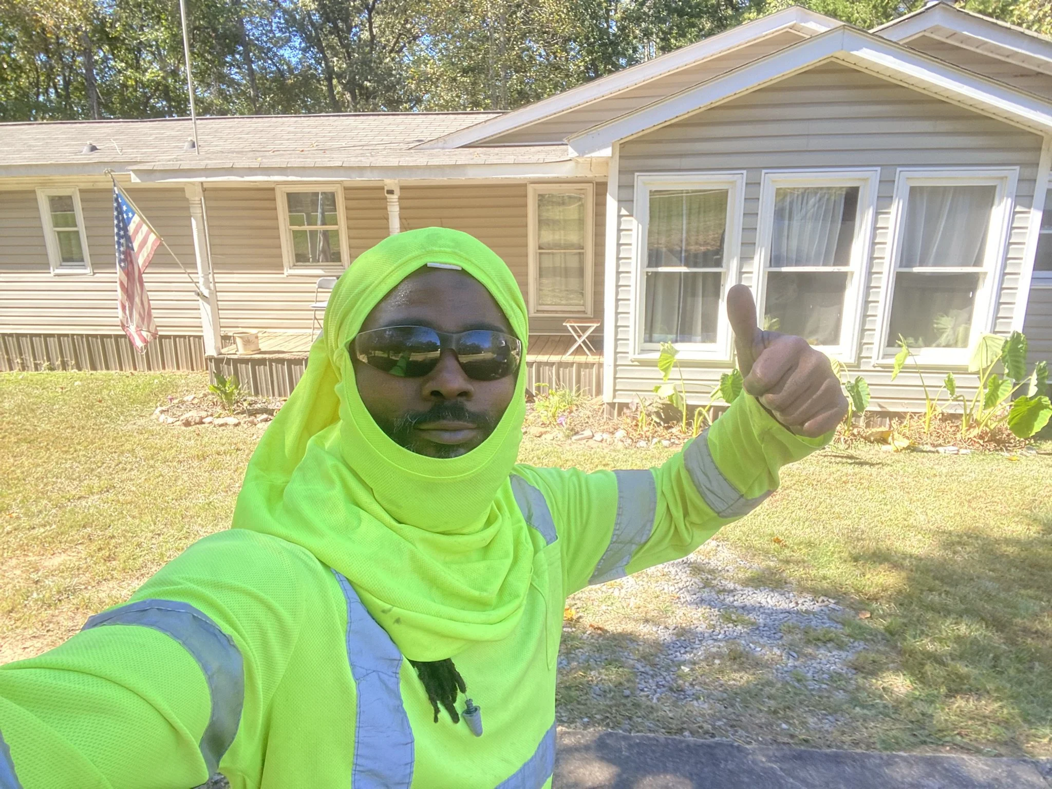 Completed residential lawn and exterior maintenance service at a single-family home.