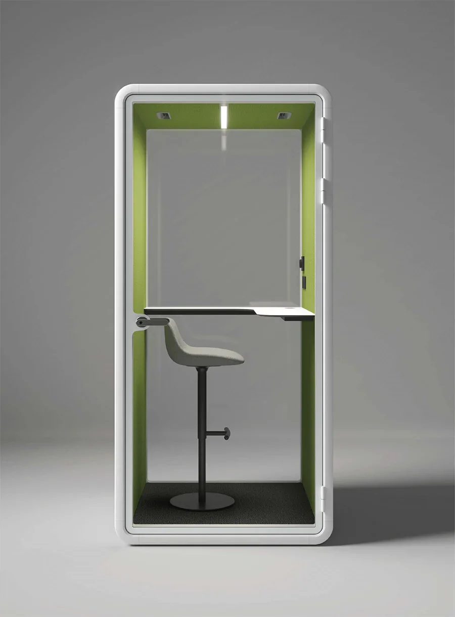 A modern, sleek privacy phone booth with a gray interior, green accents, a comfortable gray chair, and a built-in desk.