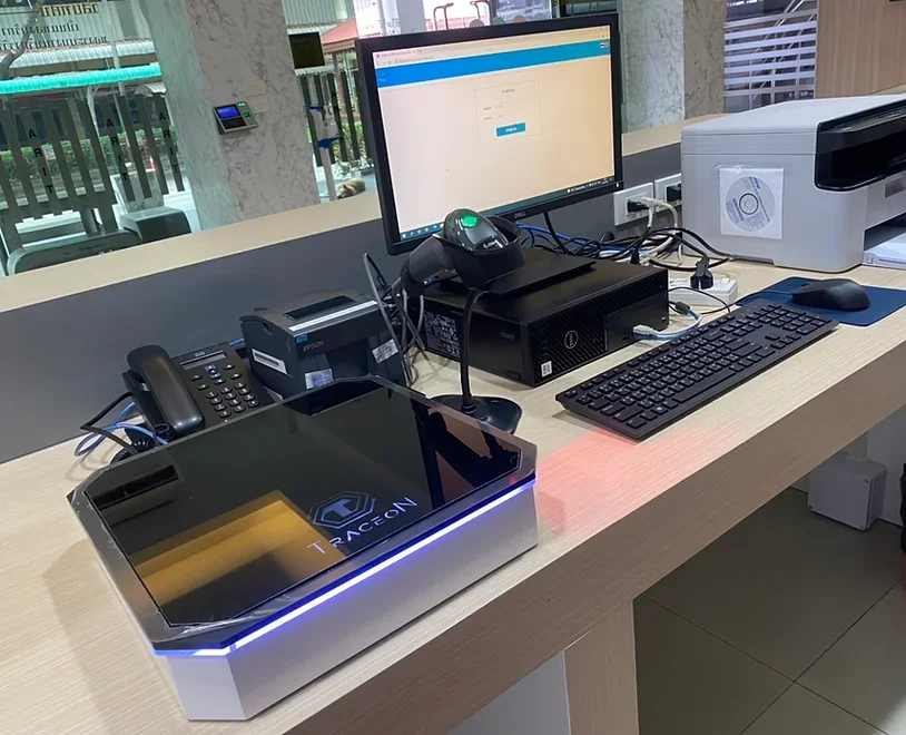 Office desk with a computer monitor, keyboard, mouse, scanner, printer, and a gaming arcade console labeled 'TRIACEON'.