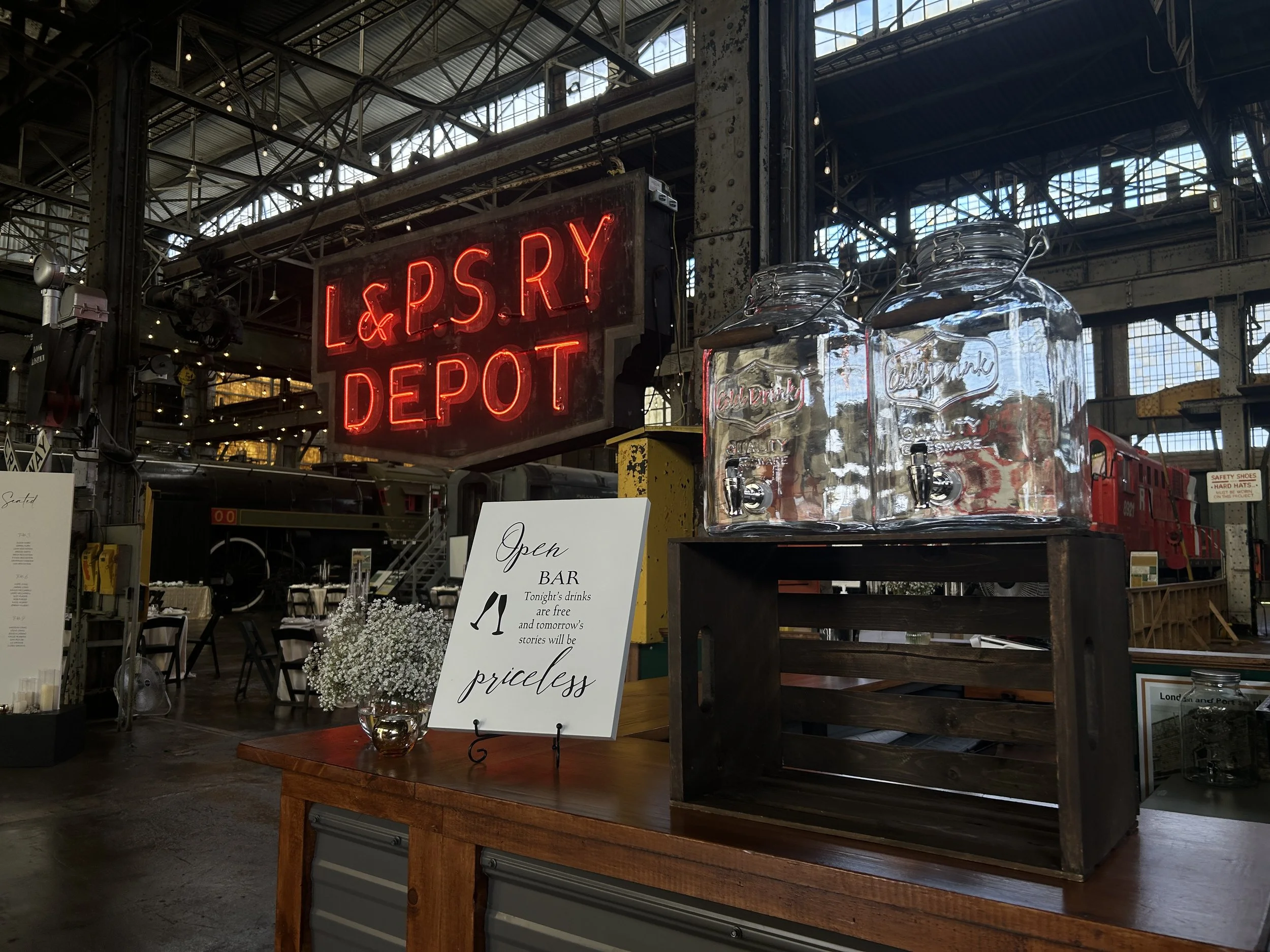 Photo featuring a wedding setup with the L&PS Railway Depot sign visible in the background