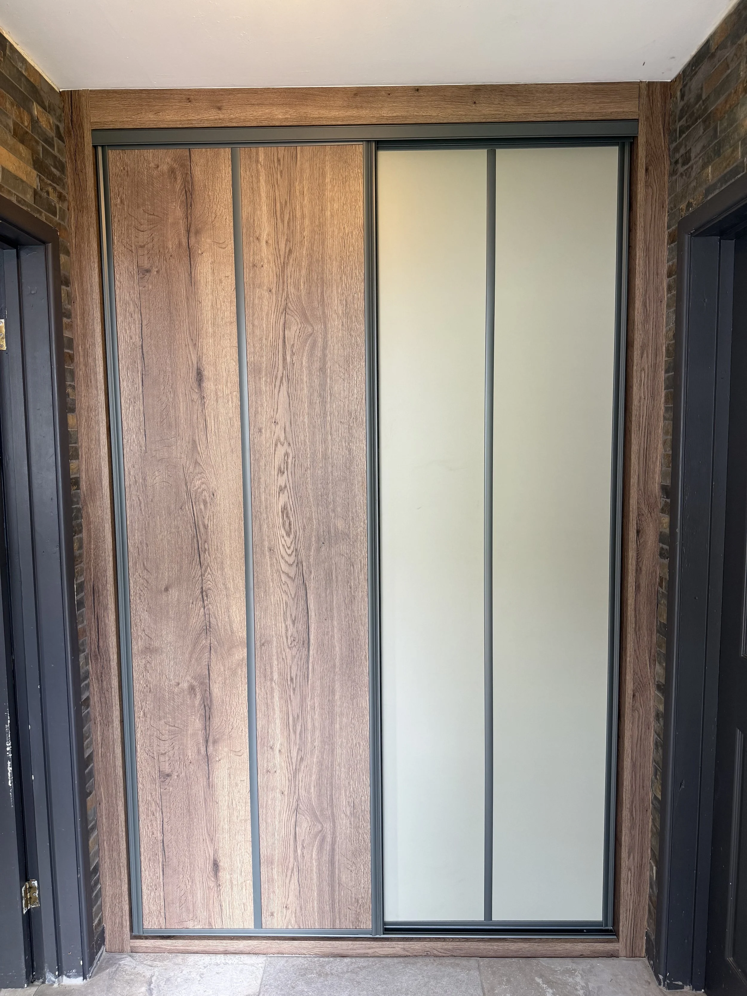 Wood panel sliding wardrobe installation by Wilkins Sliding Wardrobes