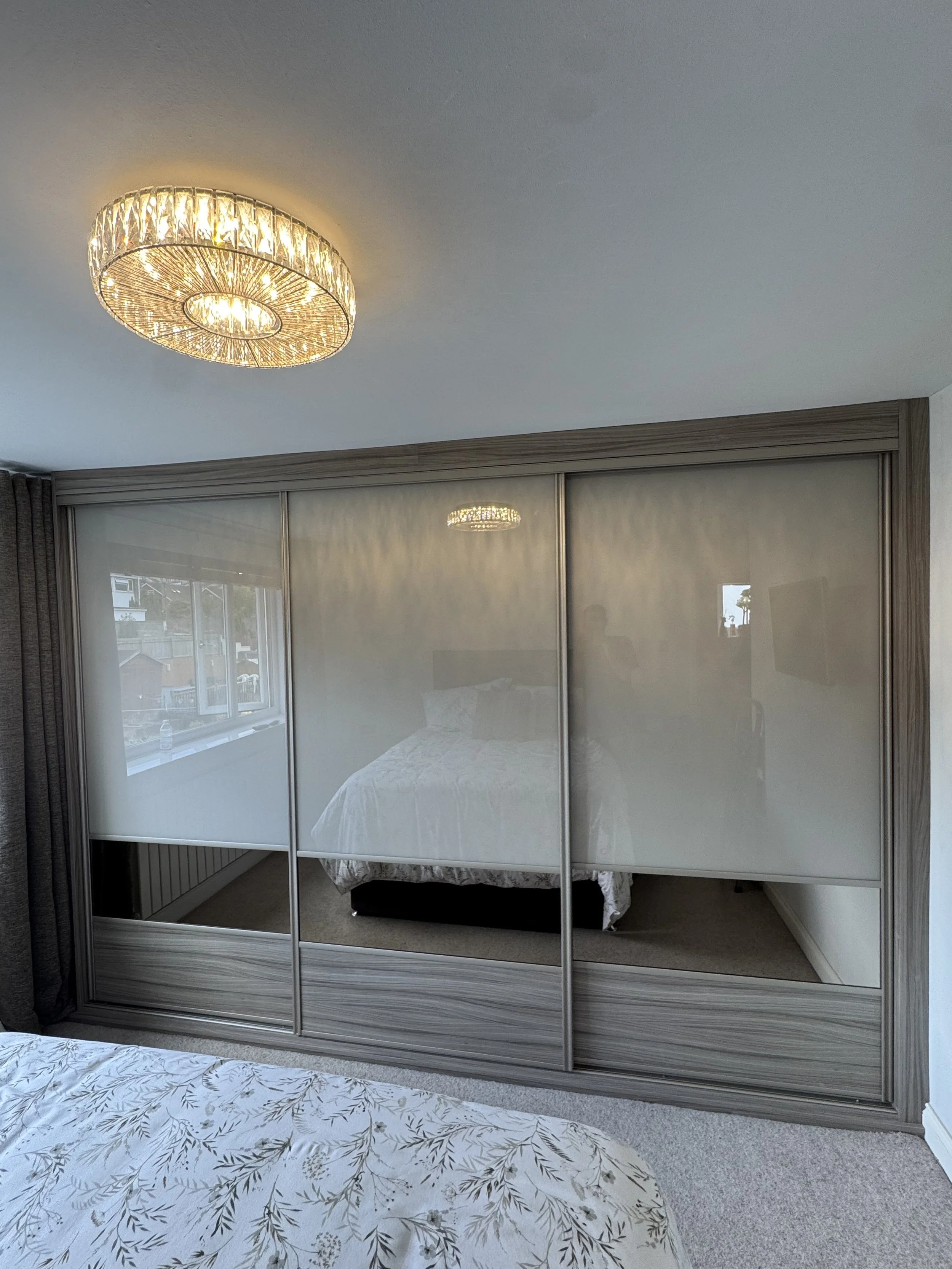 Made-to-measure sliding wardrobe featuring wood panels