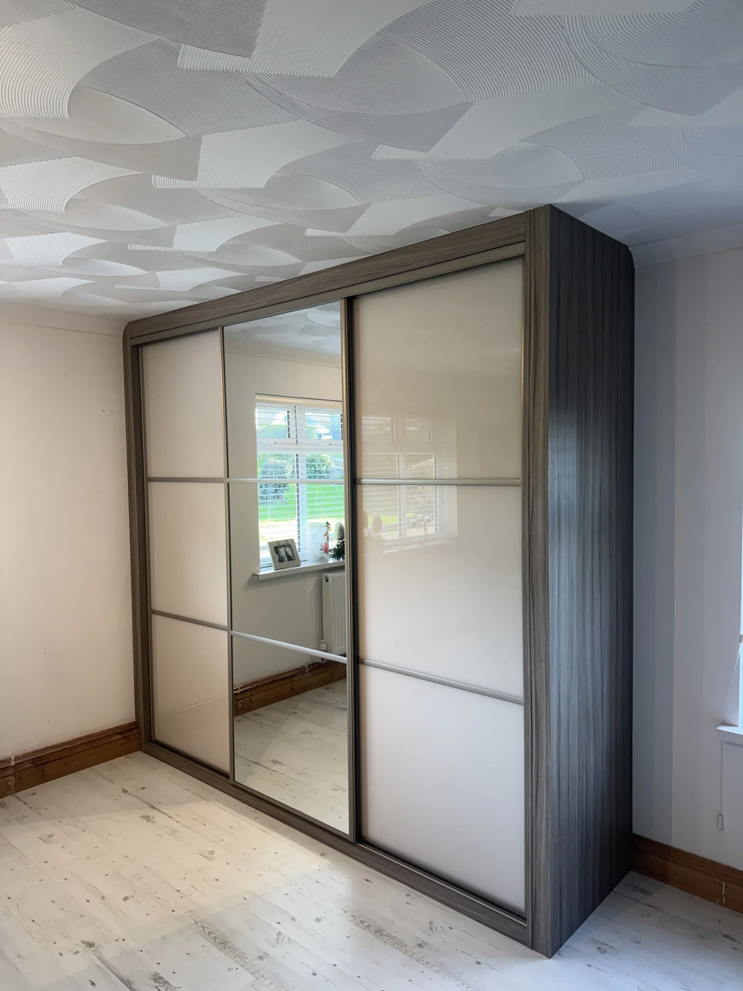 Made to measure sliding wardrobe with safety backed glass and steel running gear in South Wales