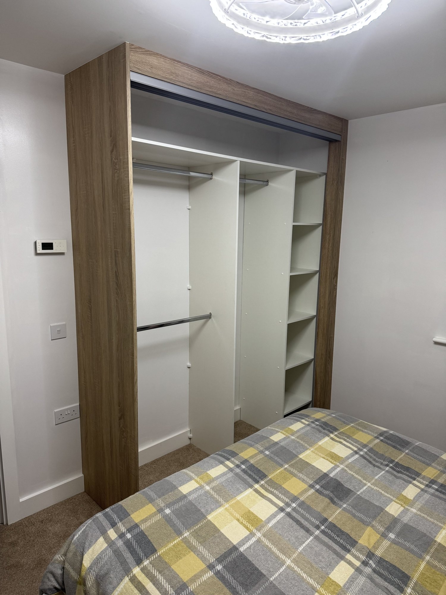 Inside wardrobe layout with shelving and hanging rail