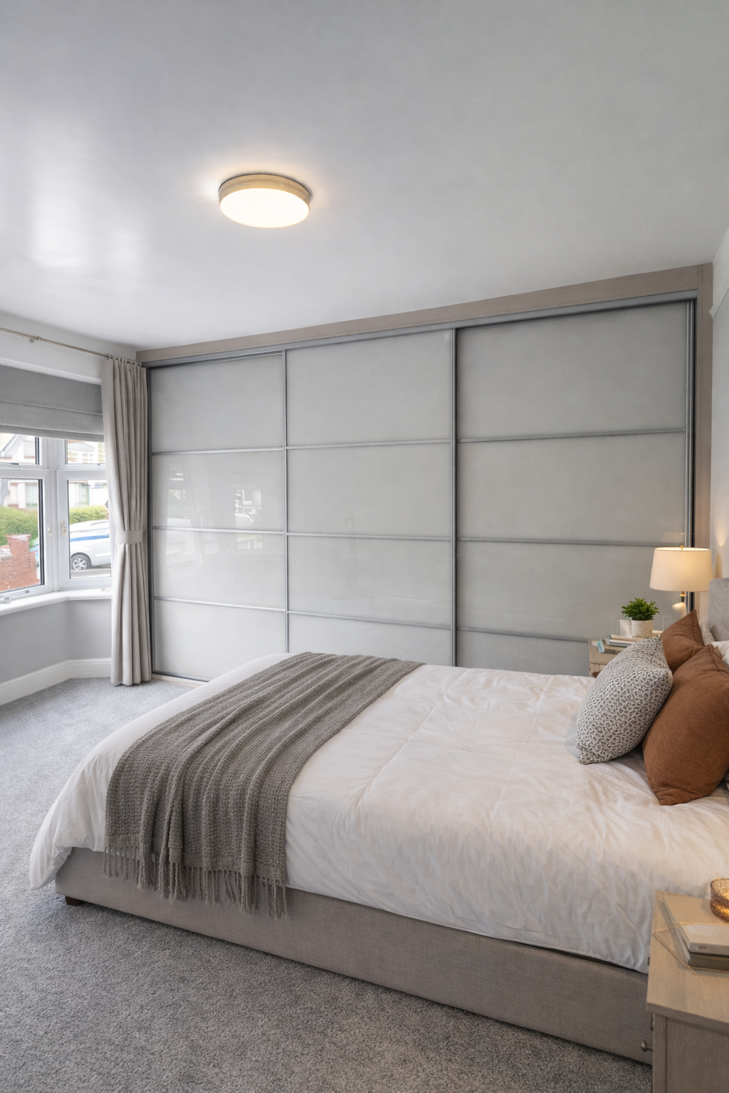 A made-to-measure 3 door sliding wardrobe fitted floor to ceiling and wall finished in cashmere