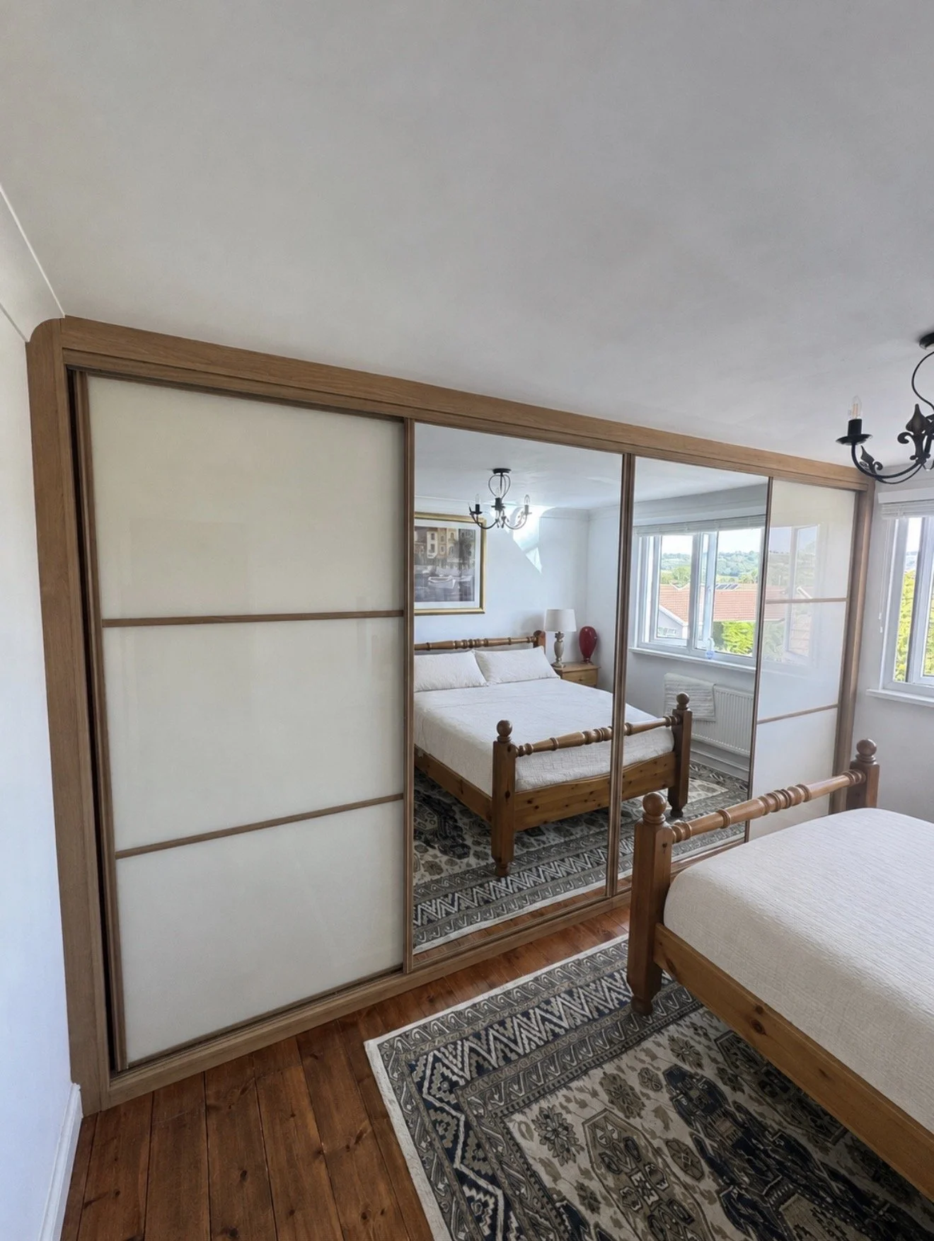 Coloured glass sliding wardrobe doors fitted by Wilkins Sliding Wardrobes