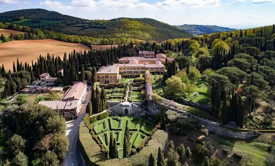 An aerial view of La Foce Hotel on a sunny afternoon in Tuscany, Italy.