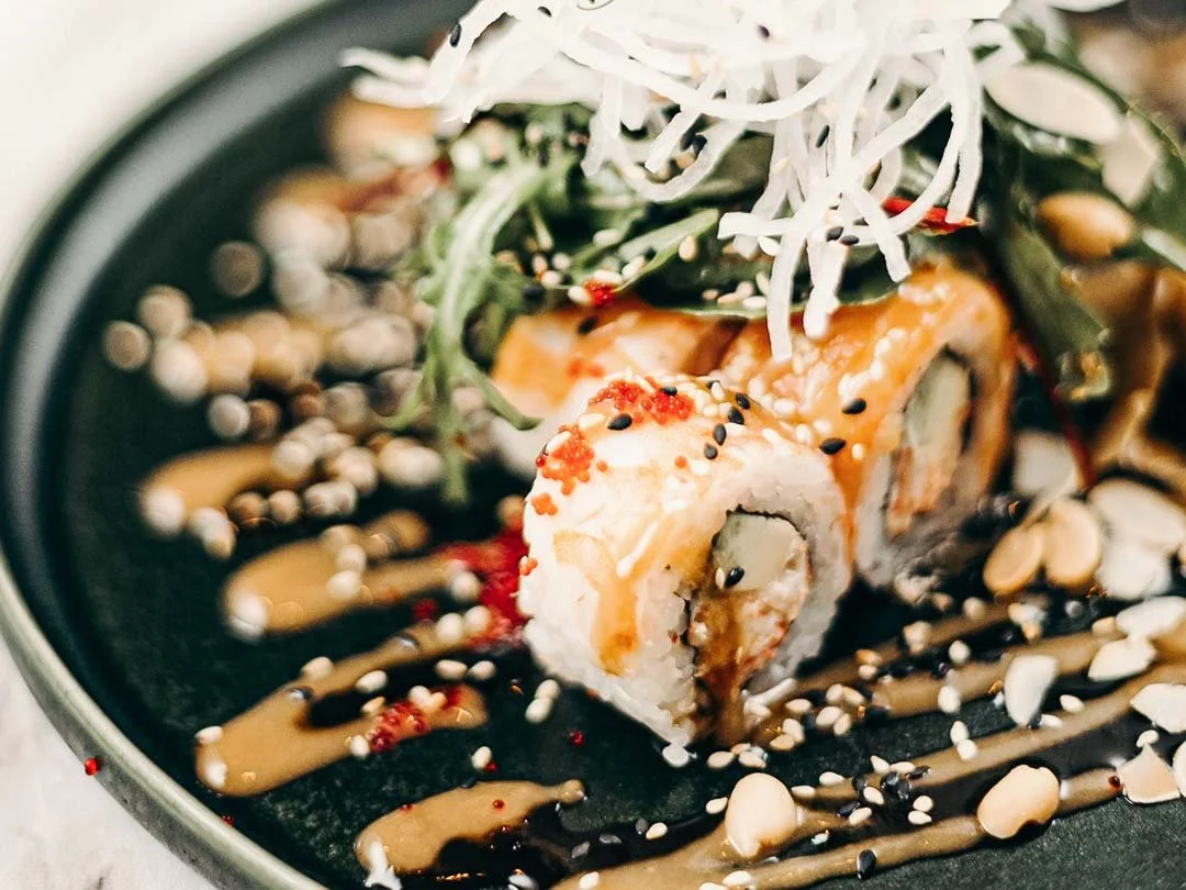 Aplate of freshly made Japanese food including Sushi.