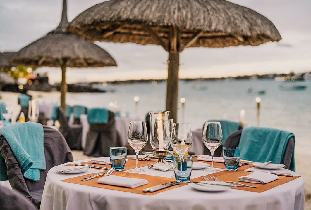 A beach table is set for dinner in Mauruitus.