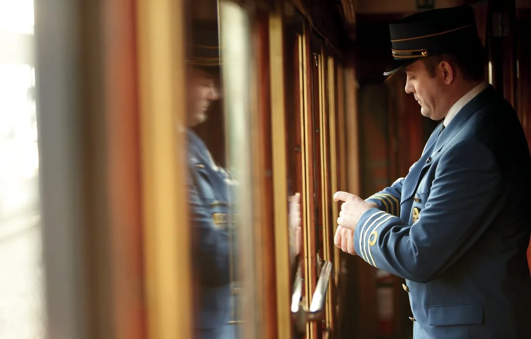 A uniformed train steward checks his watch on board the Venice Simplon-Orient-Express train.