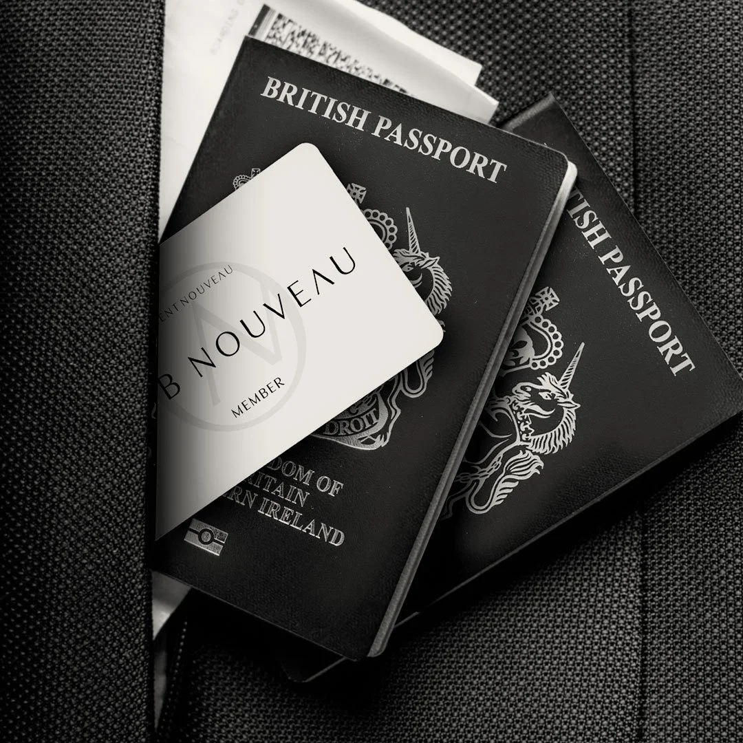 Two United Kingdom passports, a boarding pass, and a booklet resting on a textured black surface.