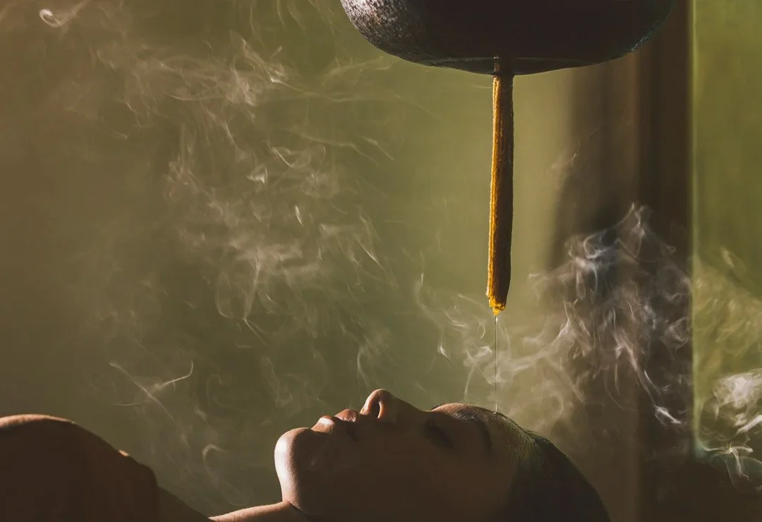 A woman enjoys a wellness aromatherapy session in peace and tranquility.