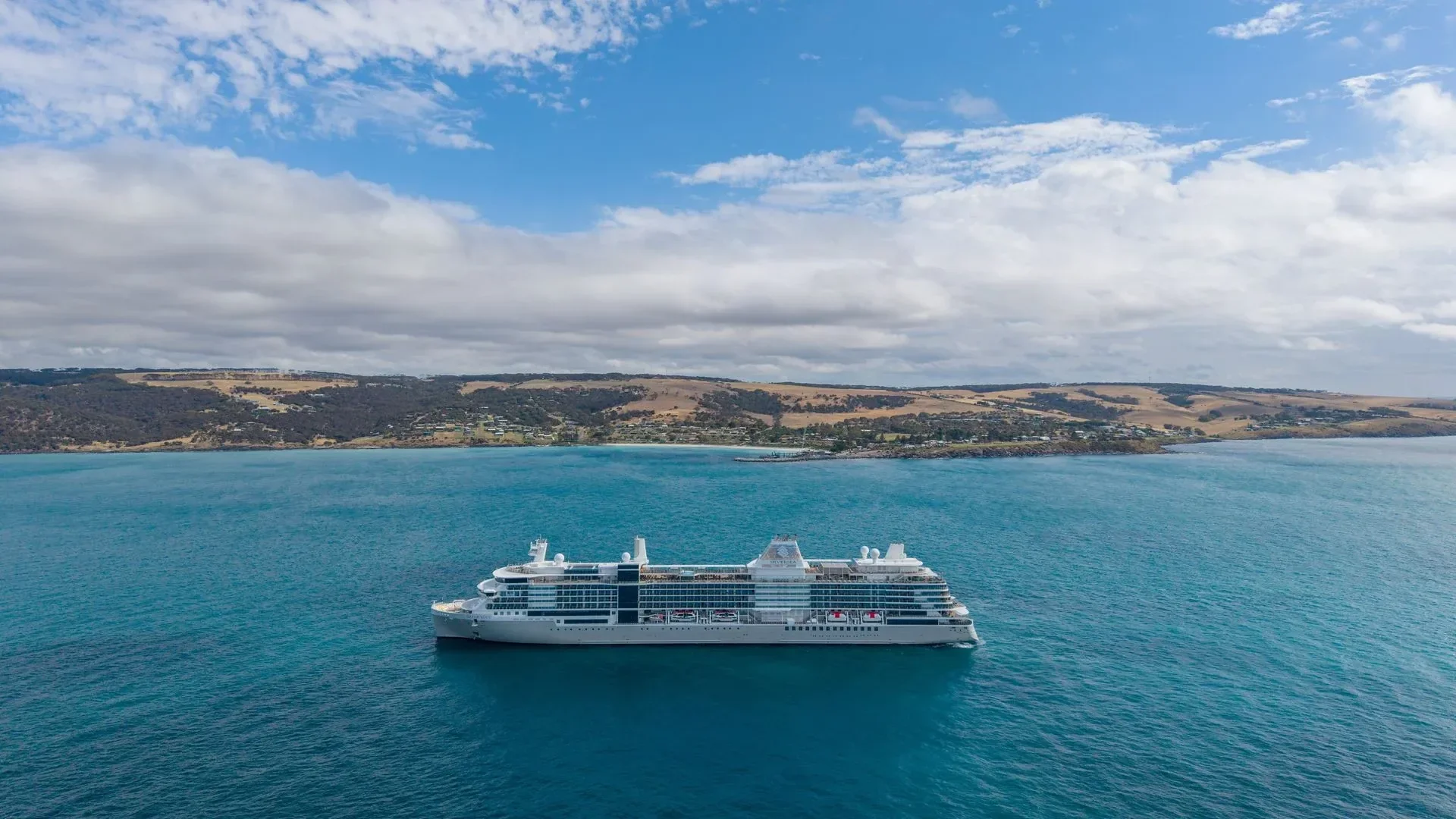 Silver Nova at sea from a wide angle, calm open water stretching to the horizon on all sides.