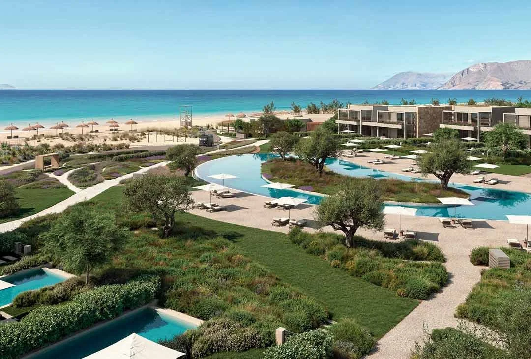 Image showing an overhead scenic view of the new Ikos resort at Kissamos. The image shows beautiful blue sea with swimming pools and manicured gardens.
