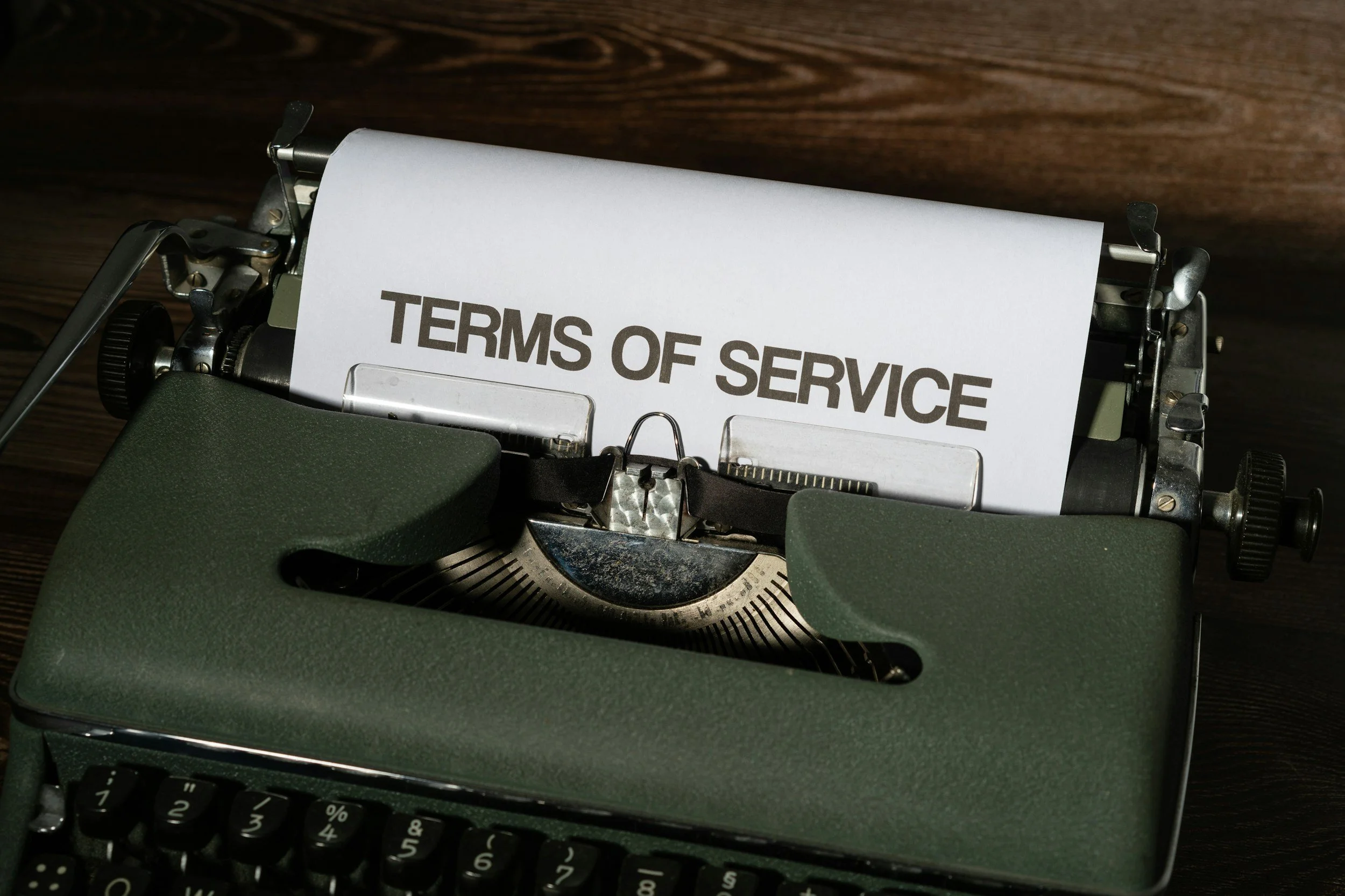 A typewriter with a paper that says 'TERMS OF SERVICE' in bold letters.
