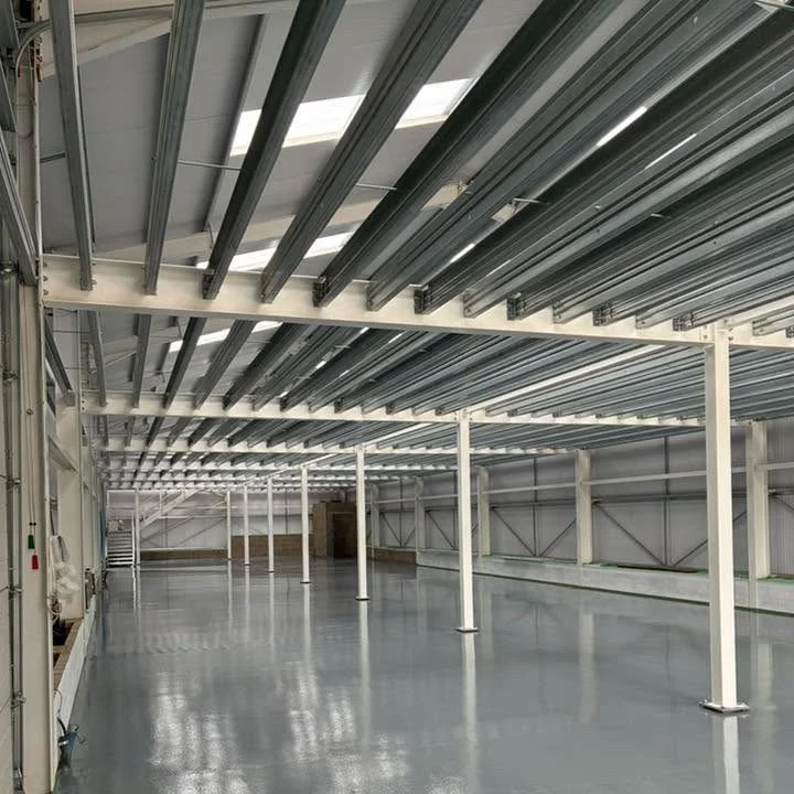Empty industrial or commercial space with metal beams and a polished concrete floor.Resin floors The Wye Valley, Herefordshire, South Wales, West Midlands, west, cardiff, birmingham, bristol