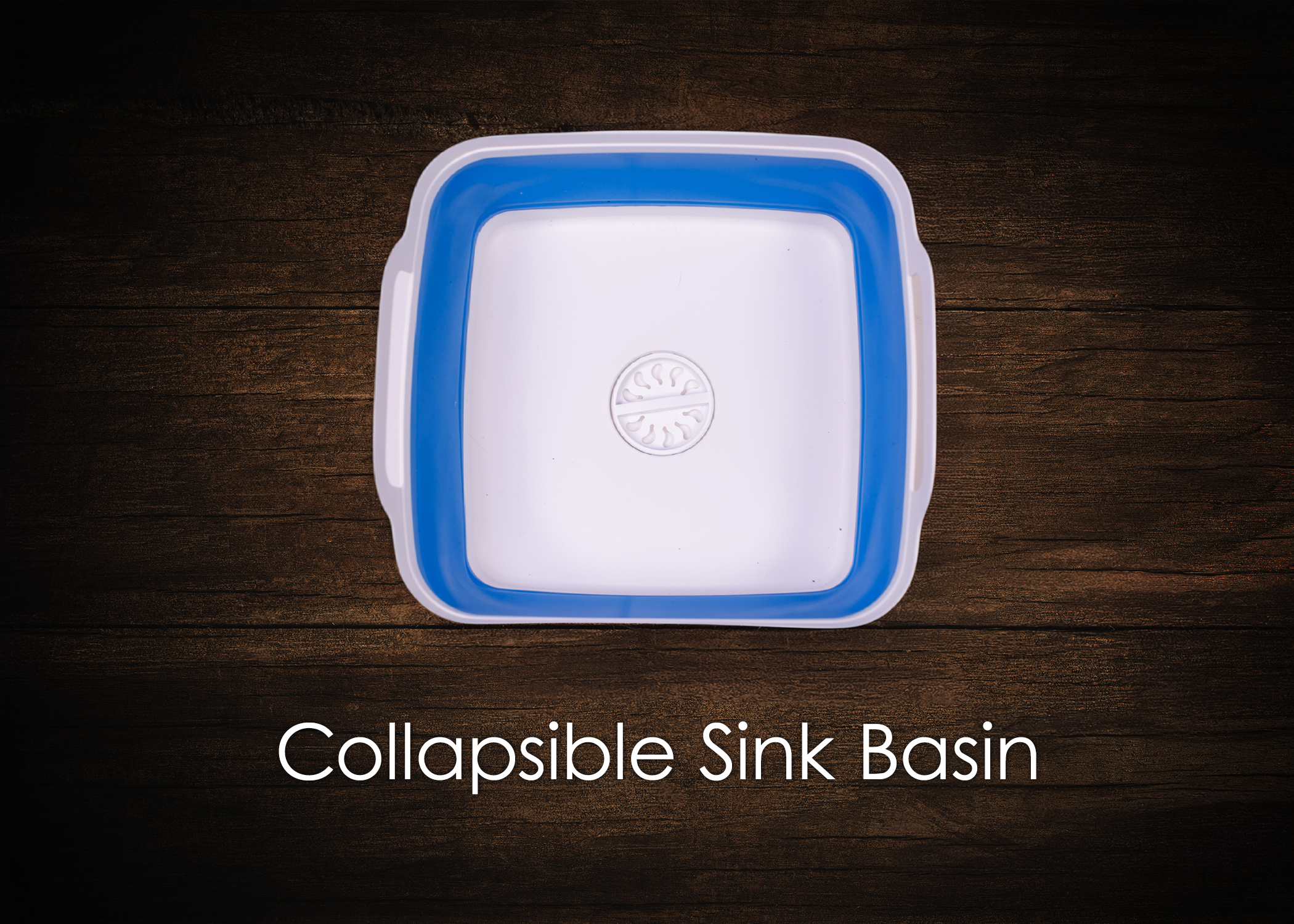Top view of a white and blue collapsible sink basin on a wooden surface with the text "Collapsible Sink Basin" below it.