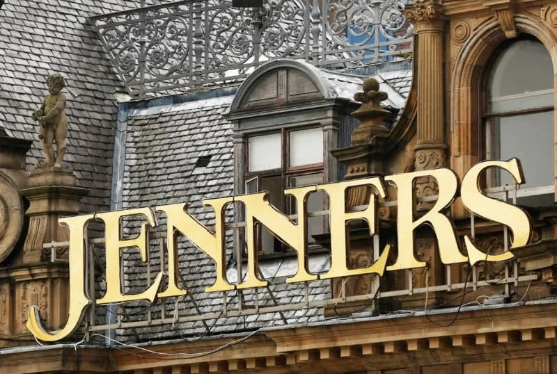 Close-up of a building's ornate facade with a prominent sign reading 'JENNER'S' in large gold letters.