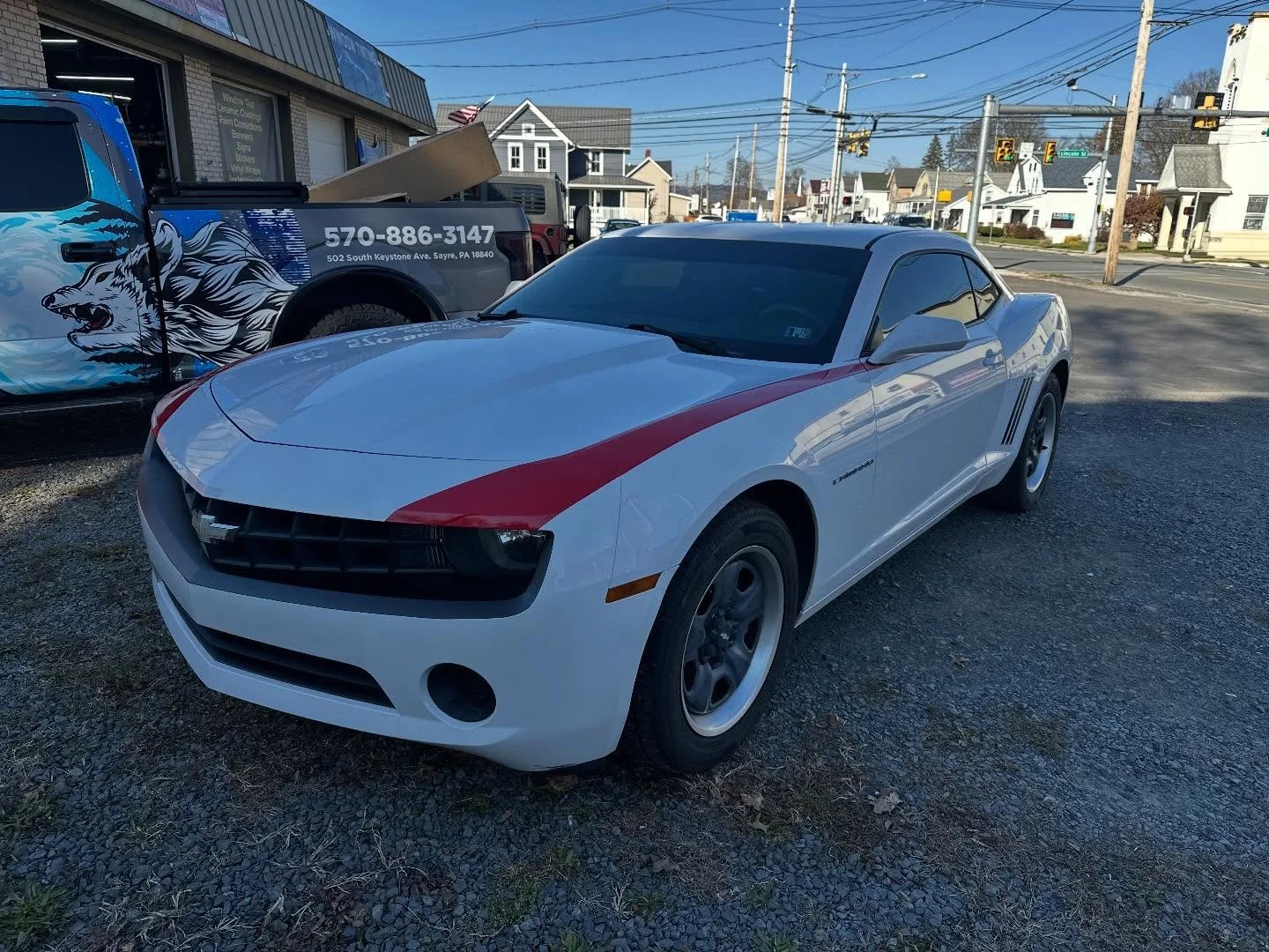 Full detail, window tint and some vinyl to change the look of this white Camaro.