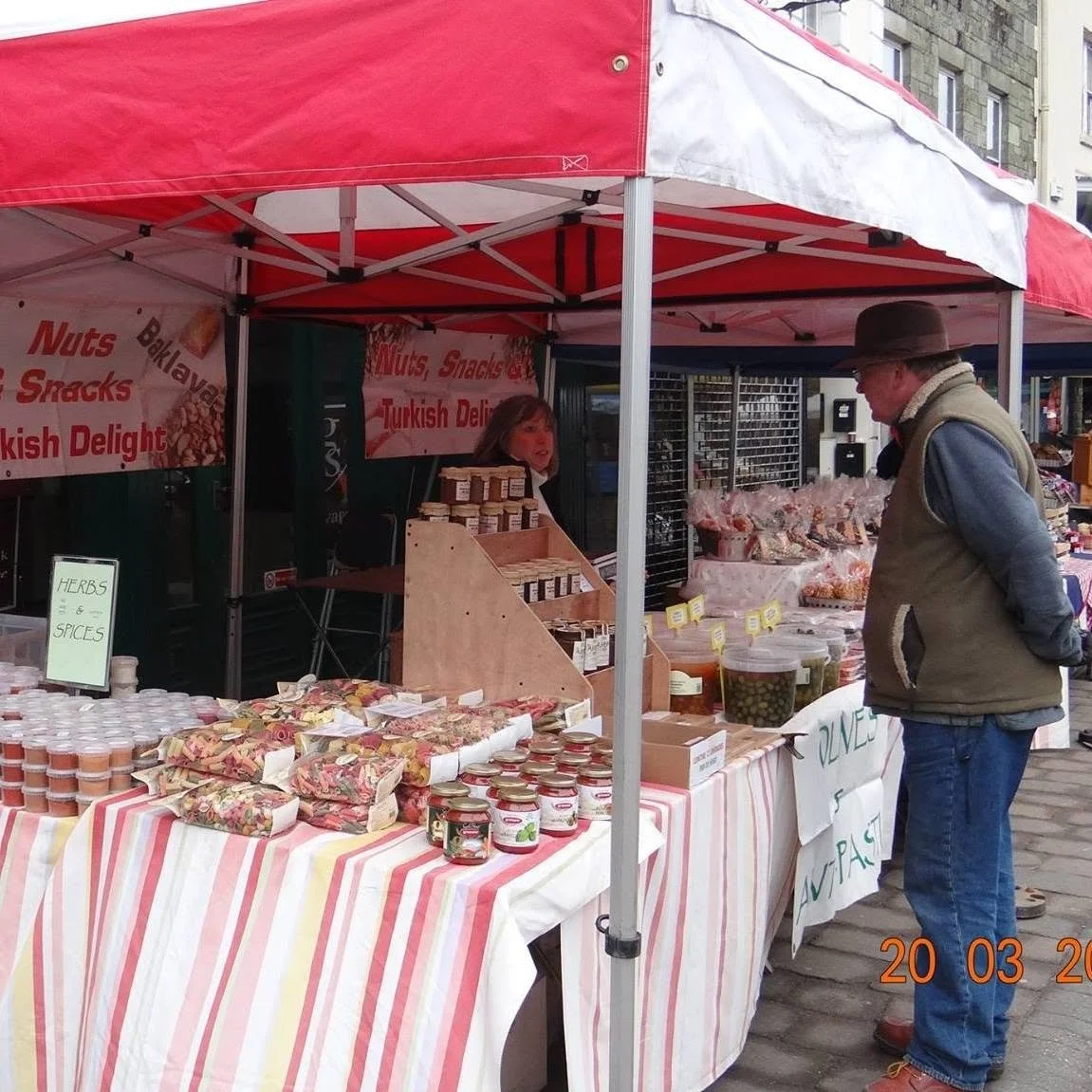 Man looking at JJ's Nut's stall