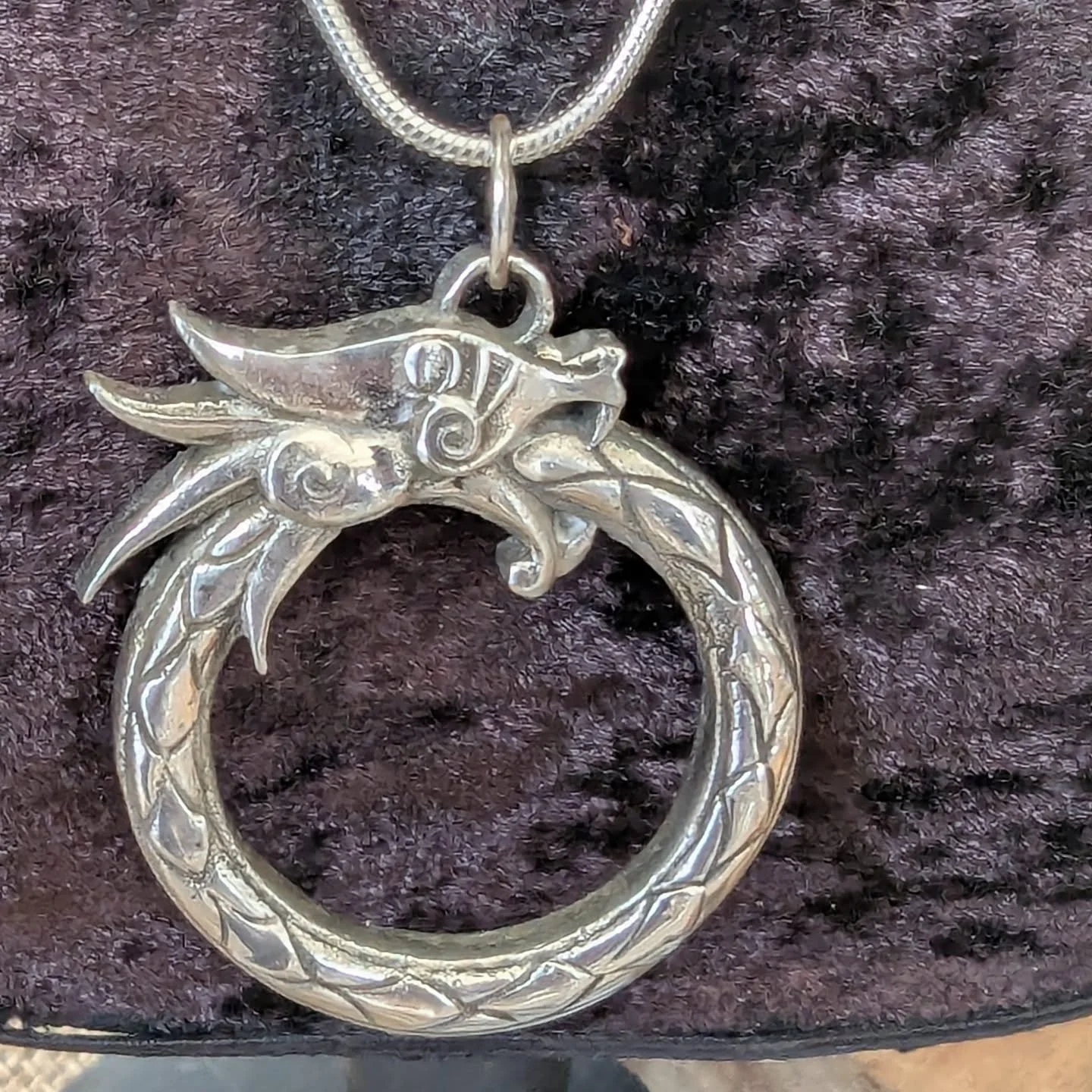 silver dragon necklace eating it's tail