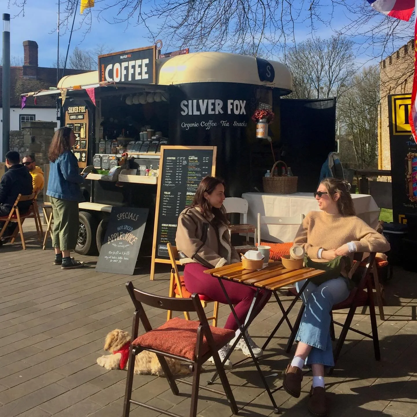 two people sitting before the mobile cafe