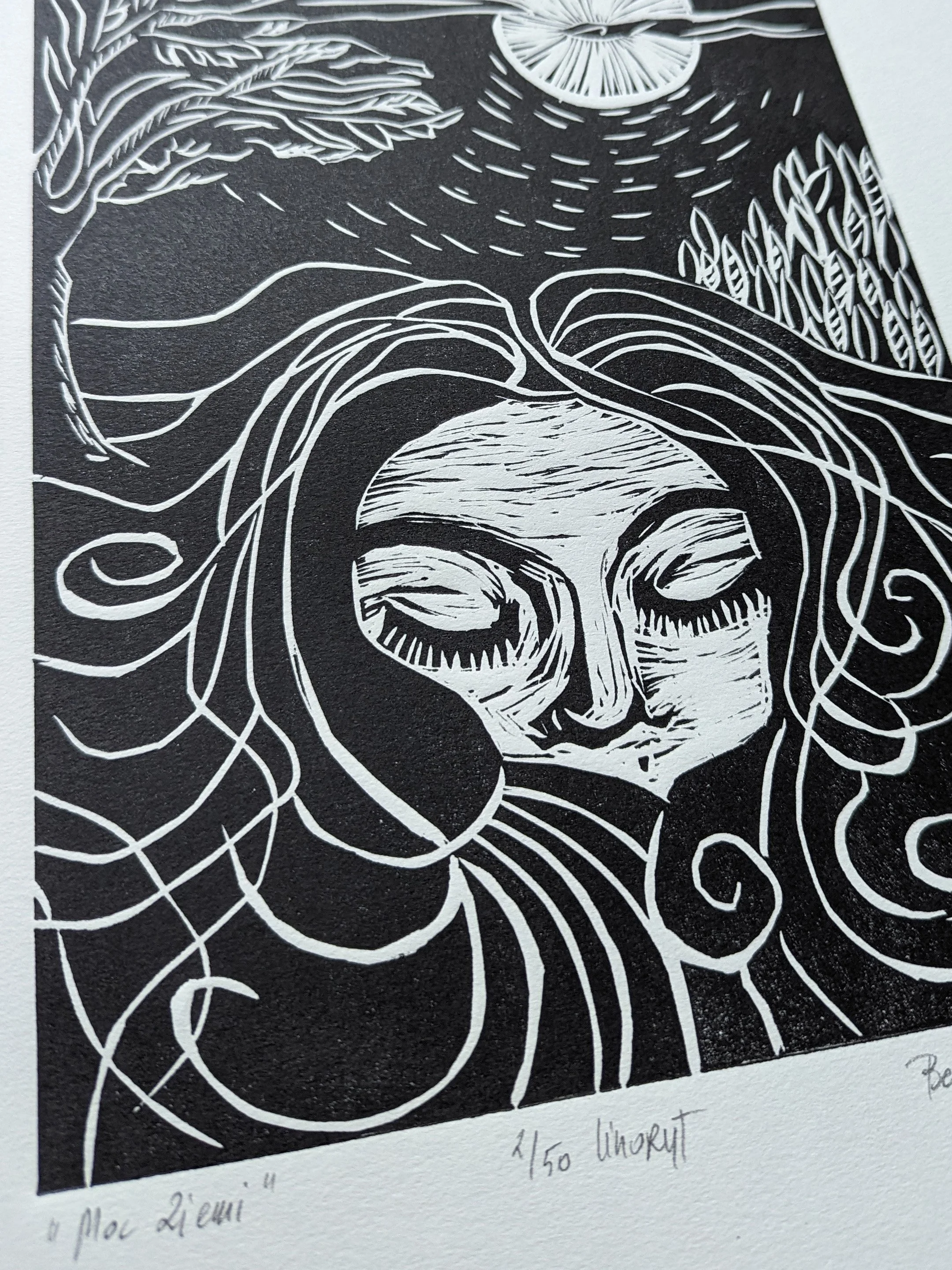 Czarno-biały artystyczny linoryt twarzy kobiety z zamkniętymi oczami, otoczonej falującymi liniami.-- Black and white artistic linocut print of a woman's face with closed eyes, surrounded by flowing lines and abstract patterns.