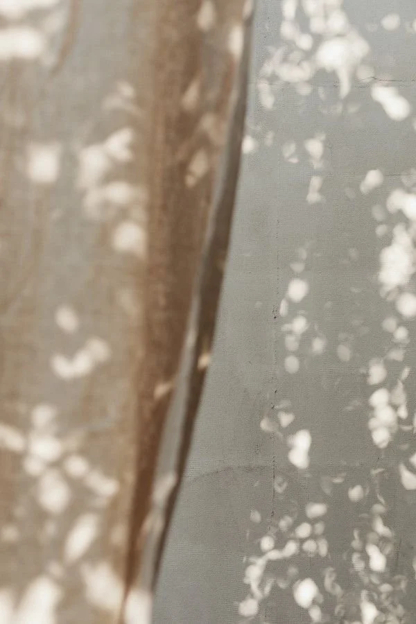 Close-up view of a transparent or reflective surface with scattered white spots and a blurred background.