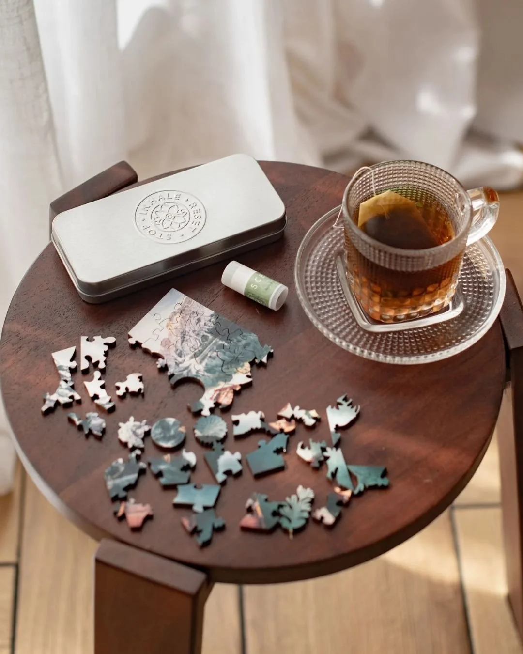 image of a coffee table with a mini puzzle and aromatherapy scentered balm