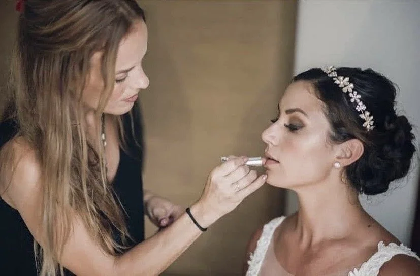Makeup artist Cecilia Acquaroli applying lipstick to bride with styled hair and pearl headband in Rome