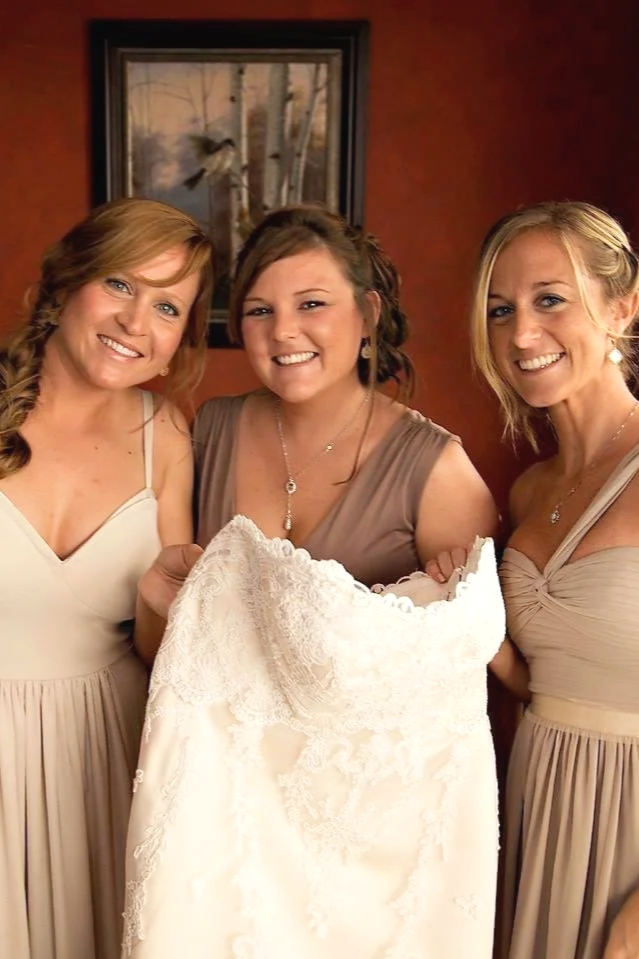 Bridesmaids preparing the wedding gown for a celebration styled by Cecilia Acquaroli. This image showcases the high-end coordination and professional atmosphere Cecilia maintains while managing styling for large bridal parties in Italy