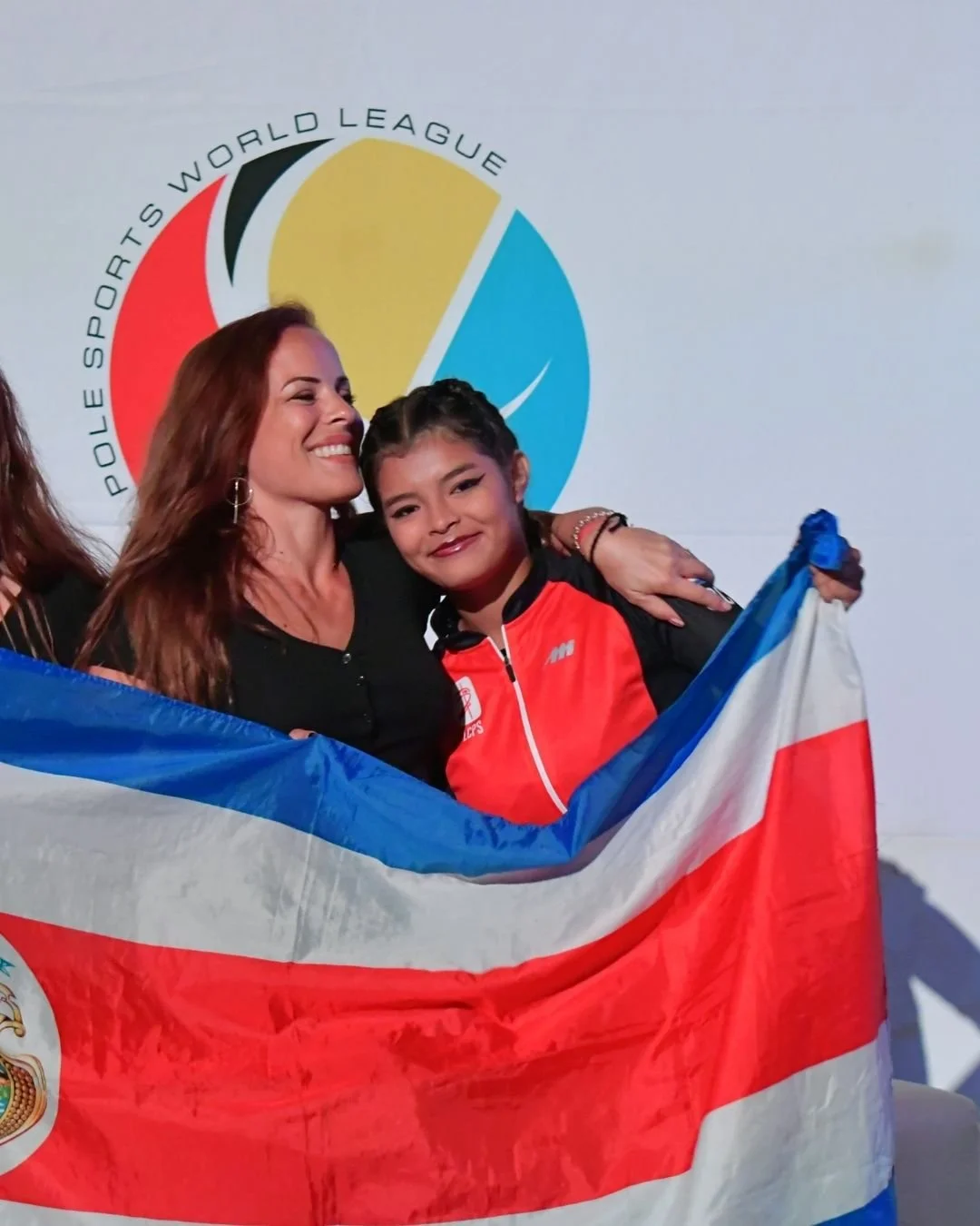 Cecilia Acquaroli celebrating with her student after winning a world championship title in Costa Rica. This photo highlights her history as an aerial arts coach and mentor, where she developed the discipline she now brings to her wedding and event bu