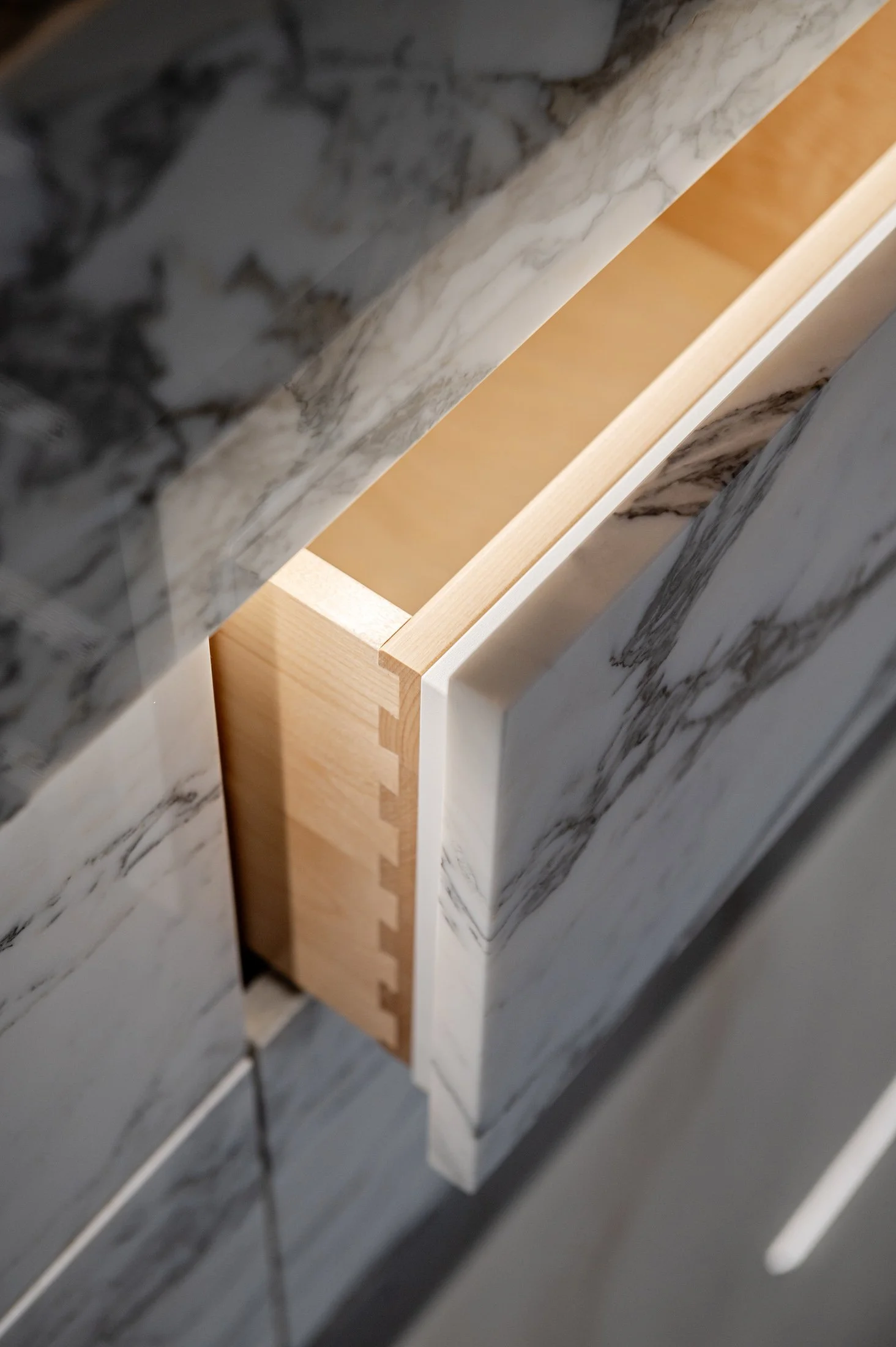 Close-up photo of a marble surface with a wooden support or frame visible underneath.