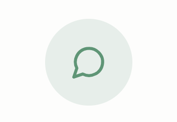 A simple green speech bubble icon on a light background.